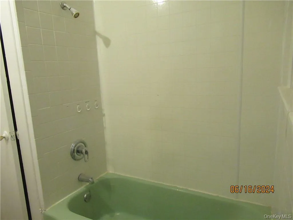 Bathroom with tiled shower / bath combo Bathroom with tiled shower / bath combo