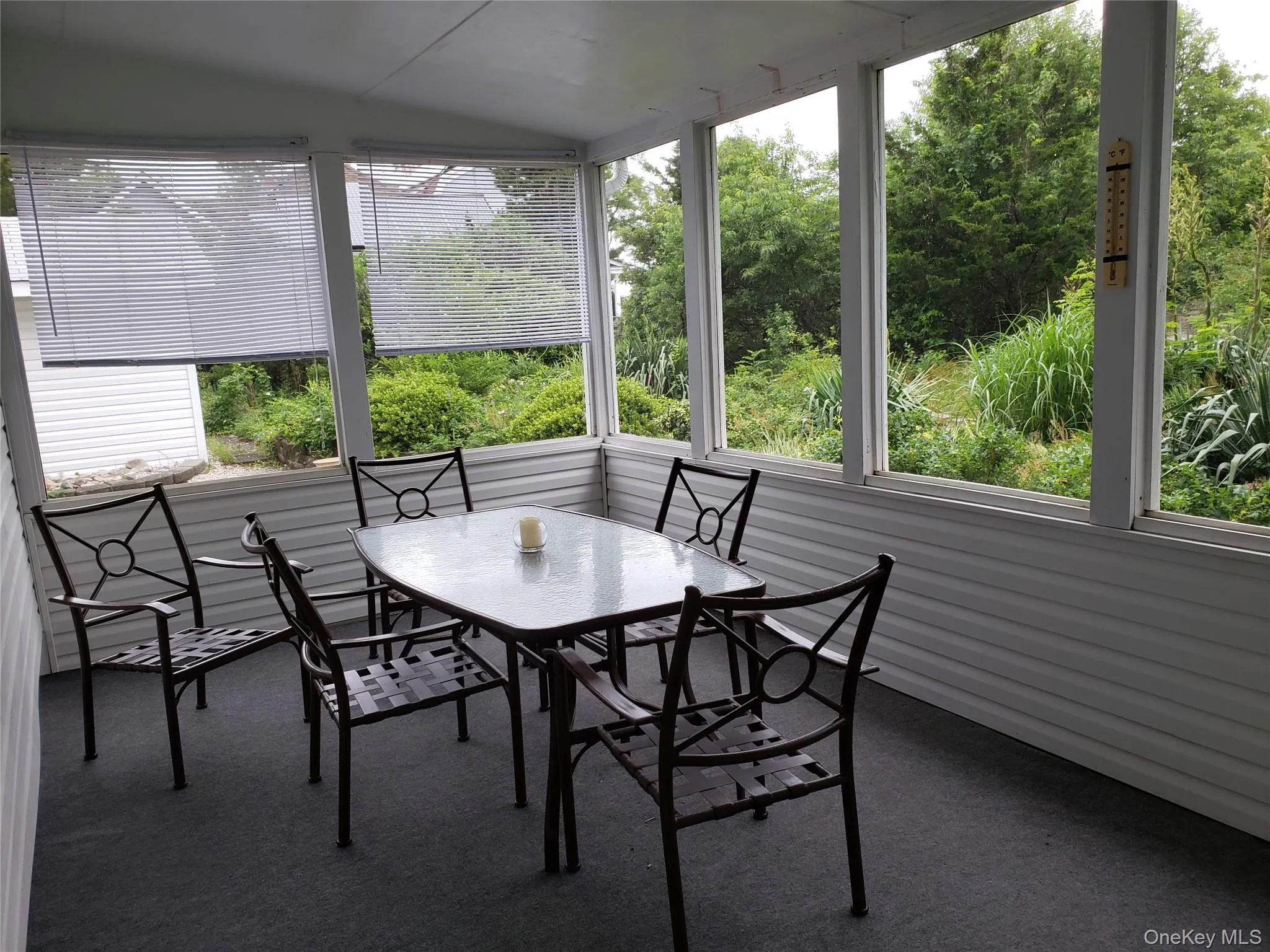Sunroom with vaulted ceiling and carpet Sunroom with vaulted ceiling and carpet