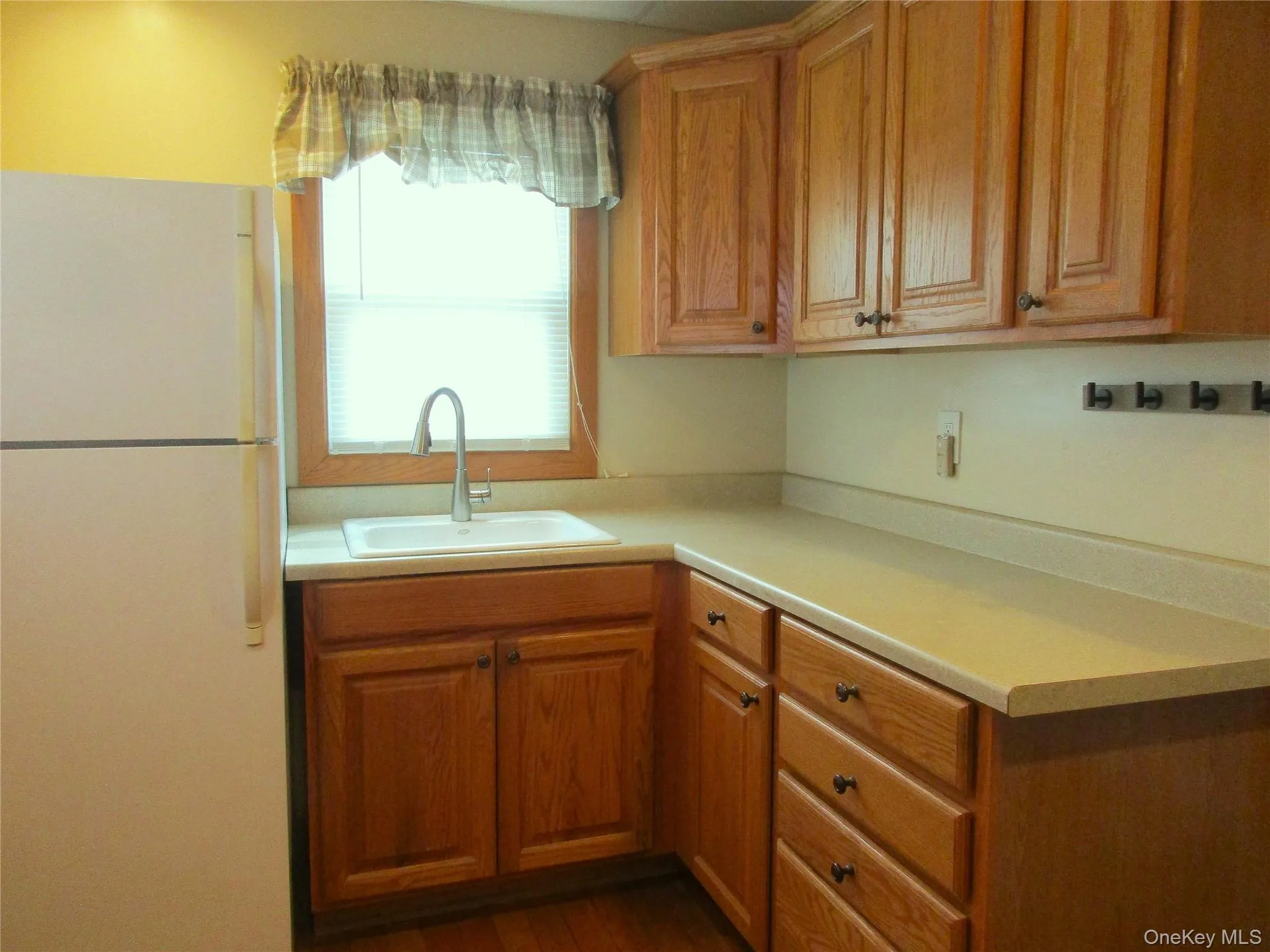 Refrigerator - Oak cabinets & sink with window over it Refrigerator - Oak cabinets & sink with window over it