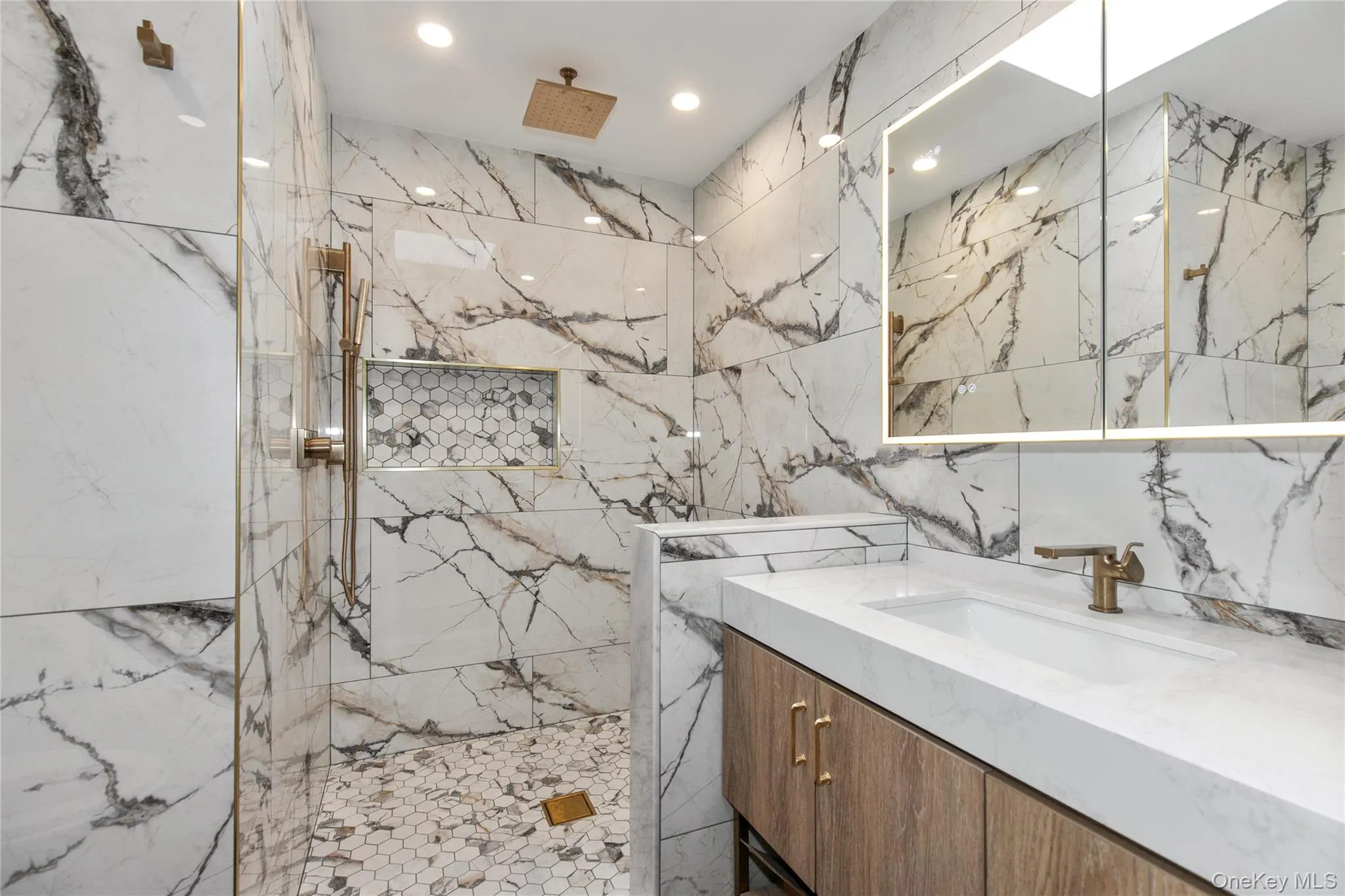Master bathroom featuring a marble finish shower, vanity, recessed lighting, stone wall, and tile walls Master bathroom featuring a marble finish shower, vanity, recessed lighting, stone wall, and tile walls