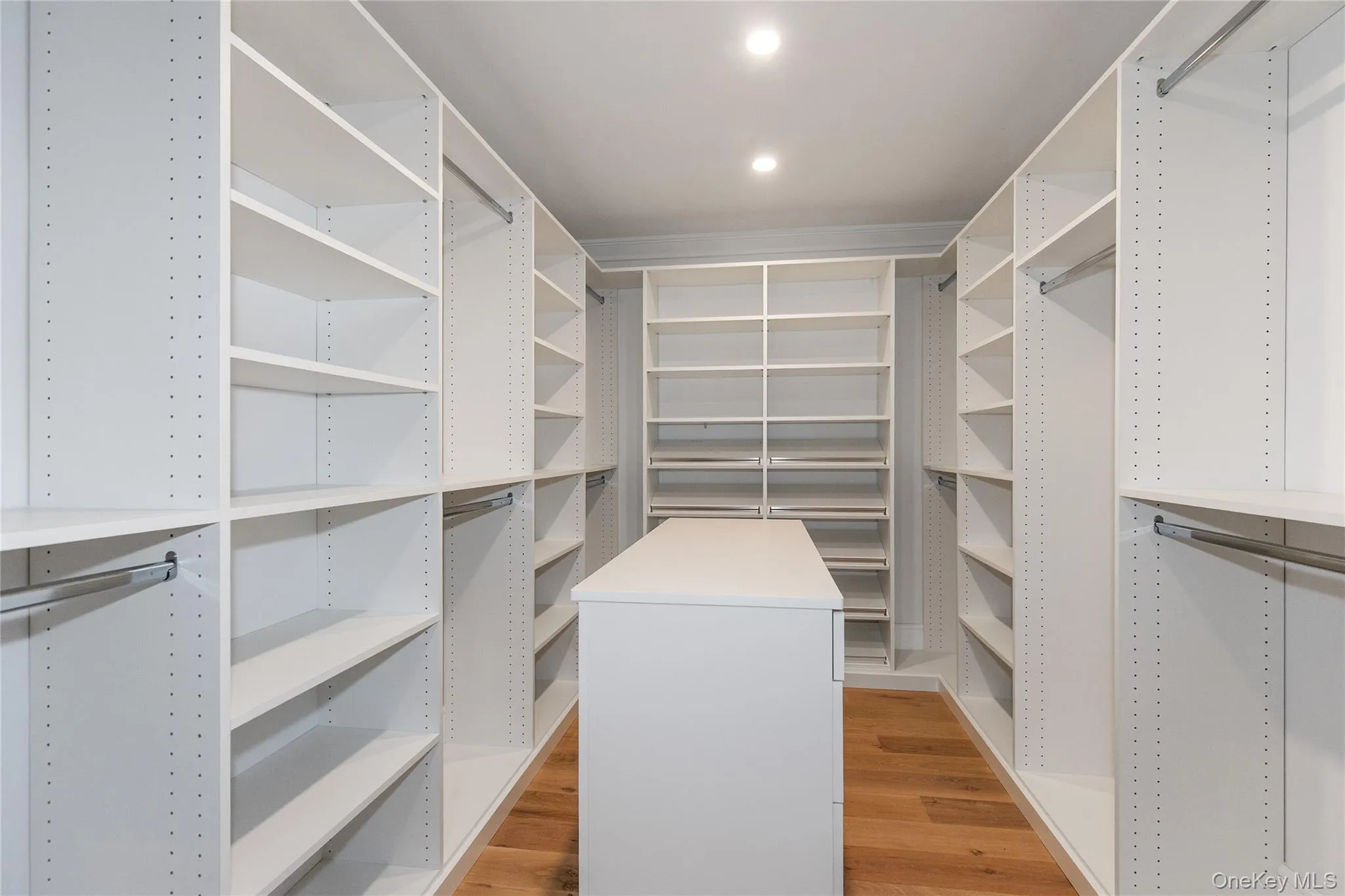 Walk in closet featuring light wood-type flooring Walk in closet featuring light wood-type flooring
