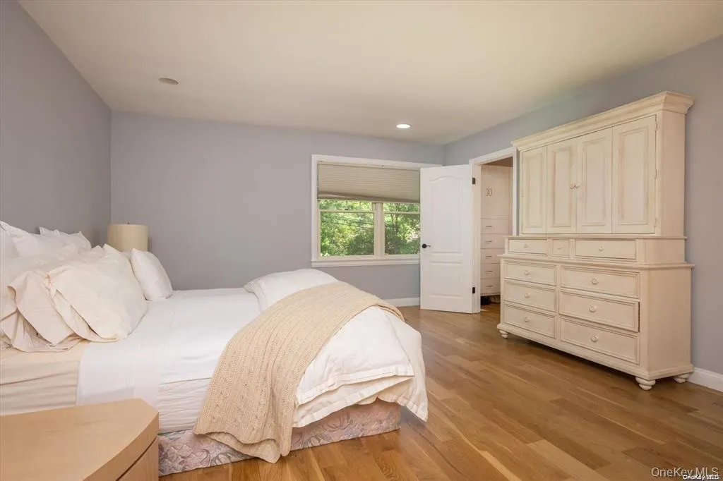 Primary Bedroom featuring light wood-type flooring and recessed lighting Primary Bedroom featuring light wood-type flooring and recessed lighting