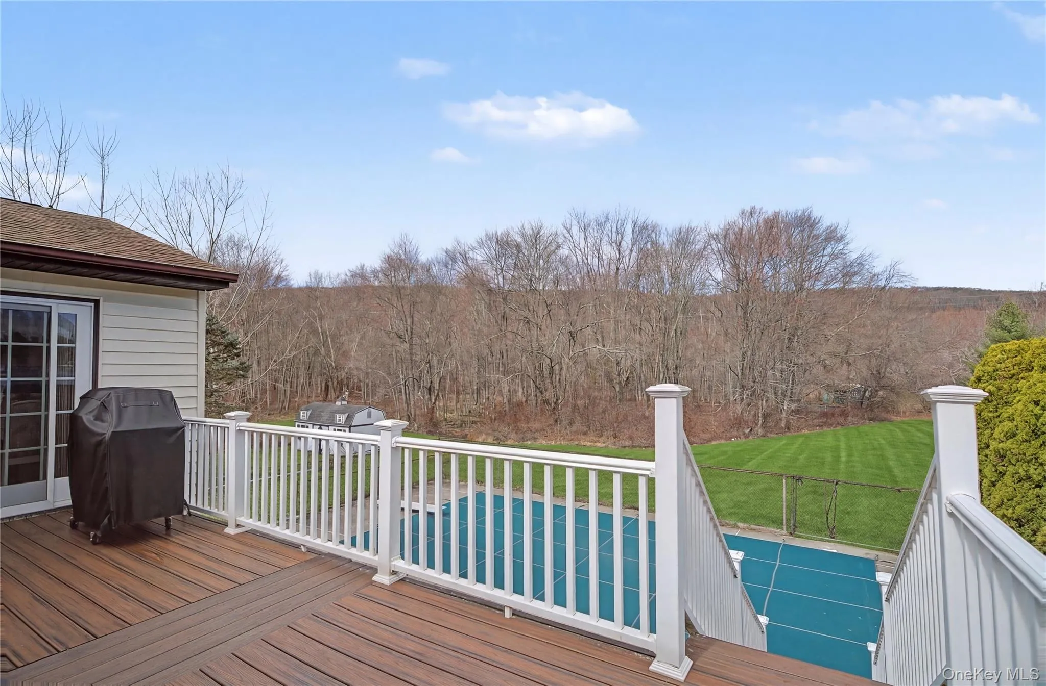Wooden deck with grilling area leading to the pool. Wooden deck with grilling area leading to the pool.
