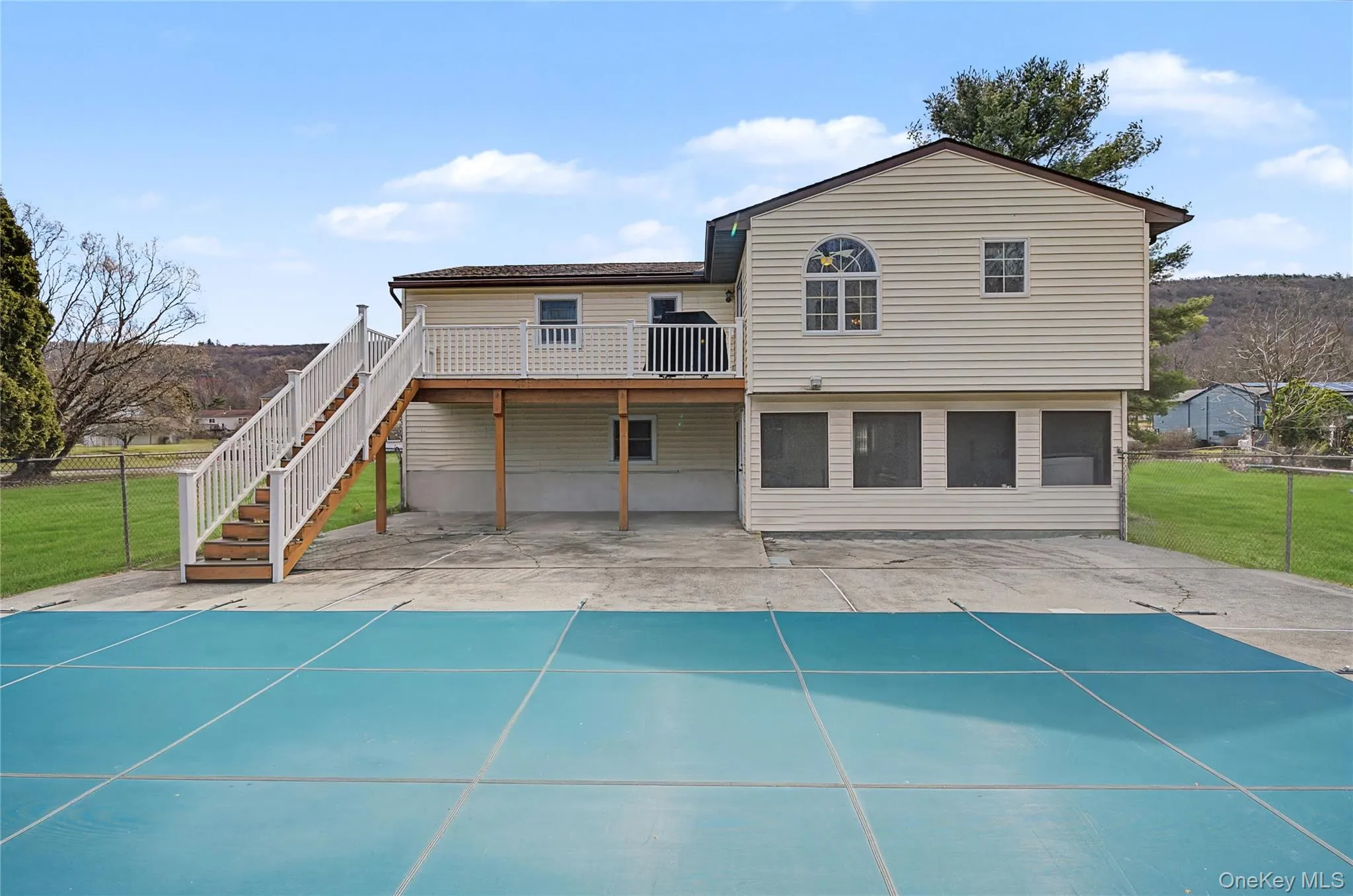 Back of property with a patio area and a deck Back of property with a patio area and a deck