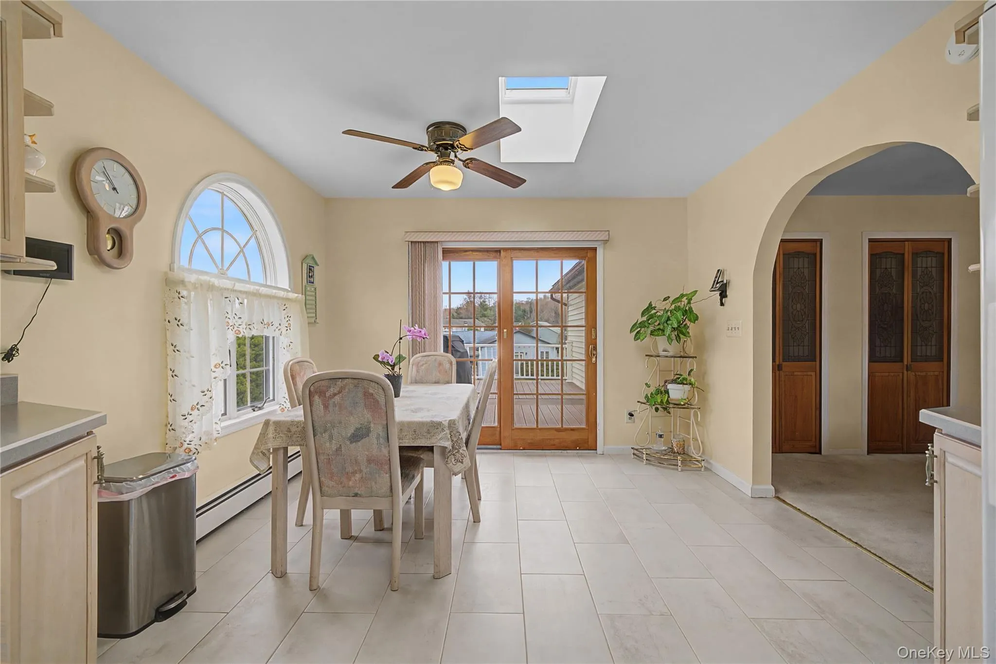 Eat In Kitchen space featuring ceiling fan, baseboard heating, plenty of natural light, and a skylight Eat In Kitchen space featuring ceiling fan, baseboard heating, plenty of natural light, and a skylight