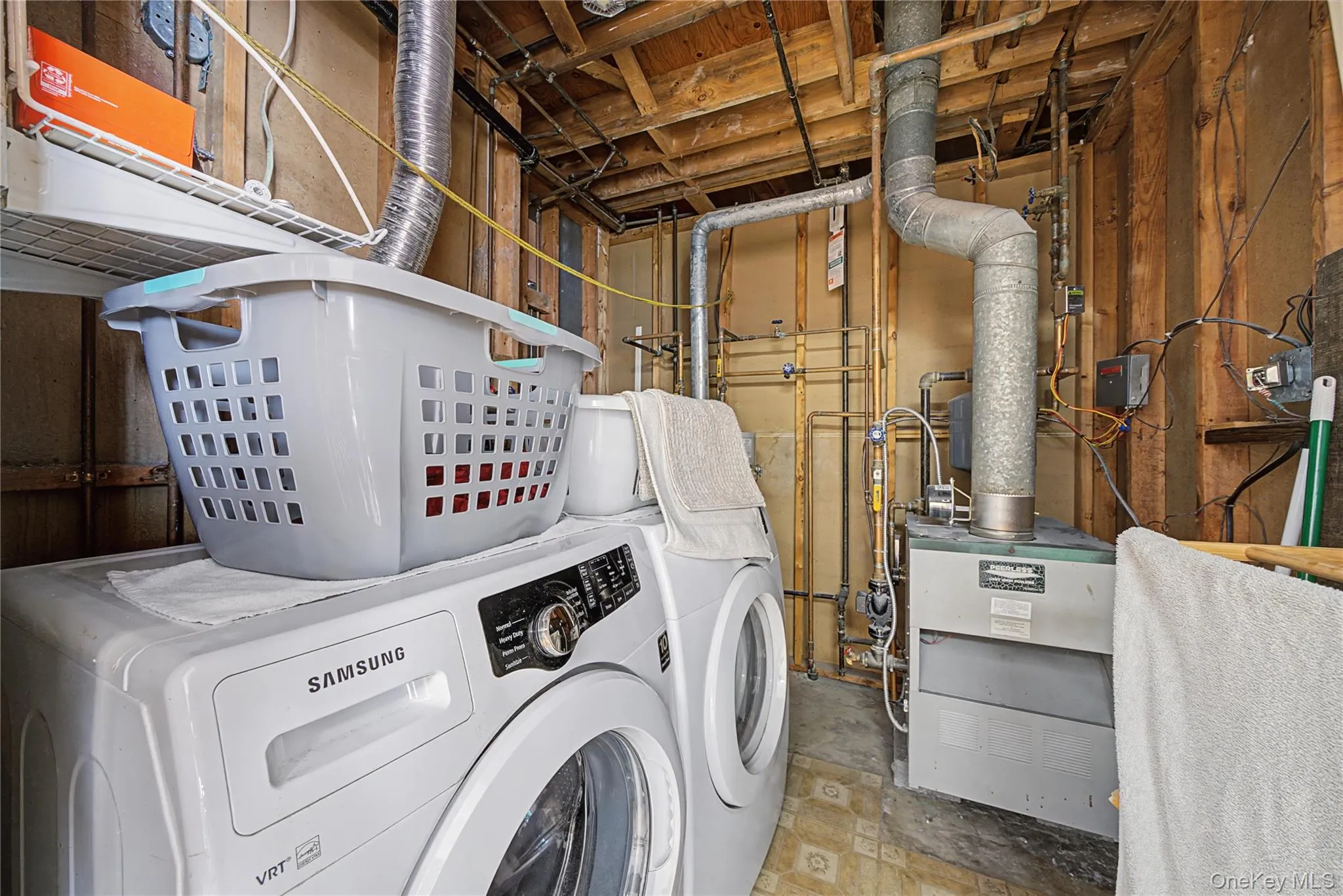 Laundry room featuring a heating unit and separate washer and dryer Laundry room featuring a heating unit and separate washer and dryer