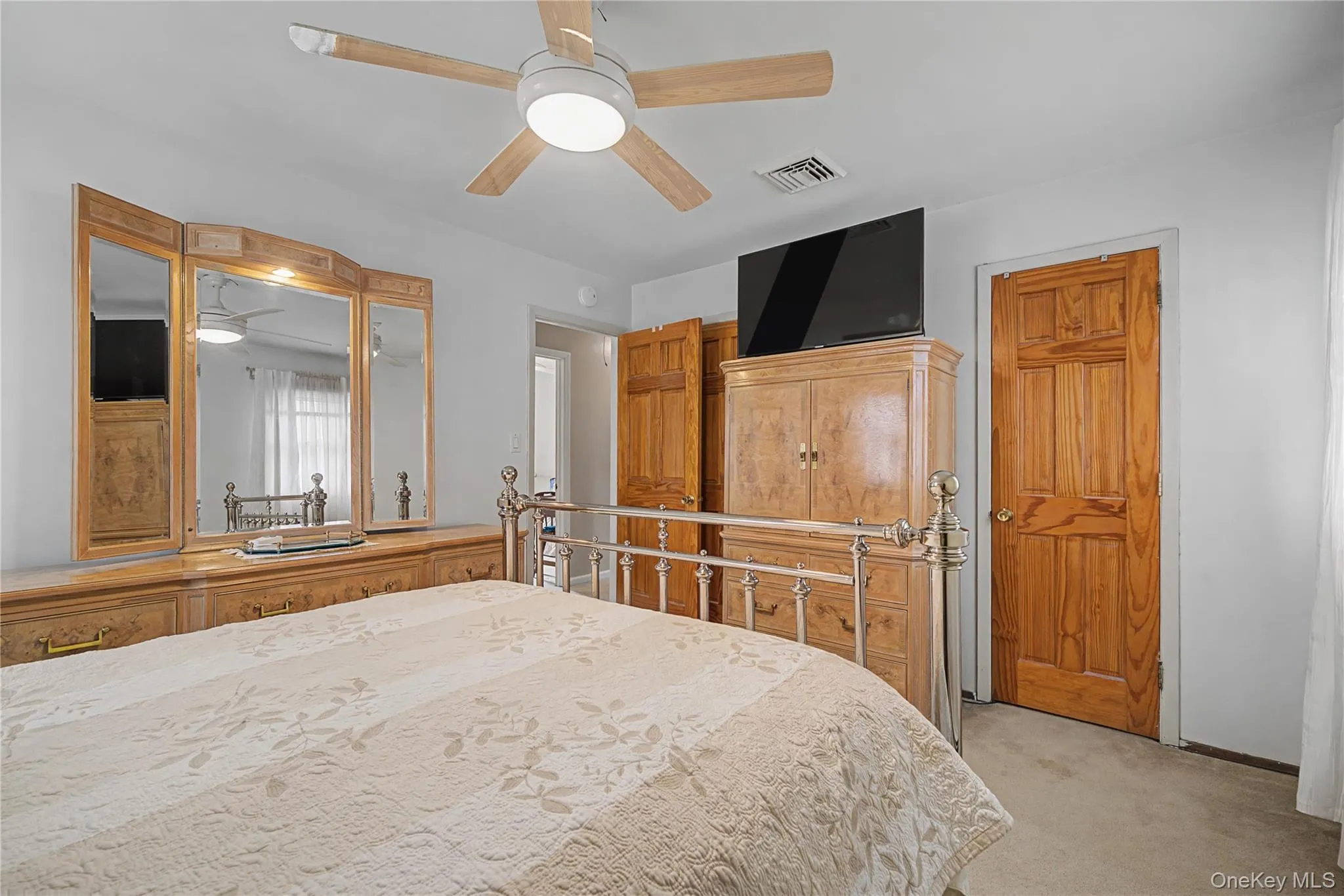 Bedroom featuring light carpet and ceiling fan Bedroom featuring light carpet and ceiling fan