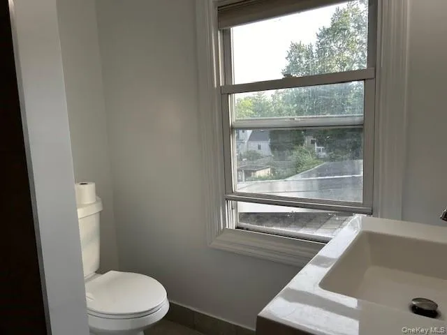 Bathroom featuring toilet and sink Bathroom featuring toilet and sink