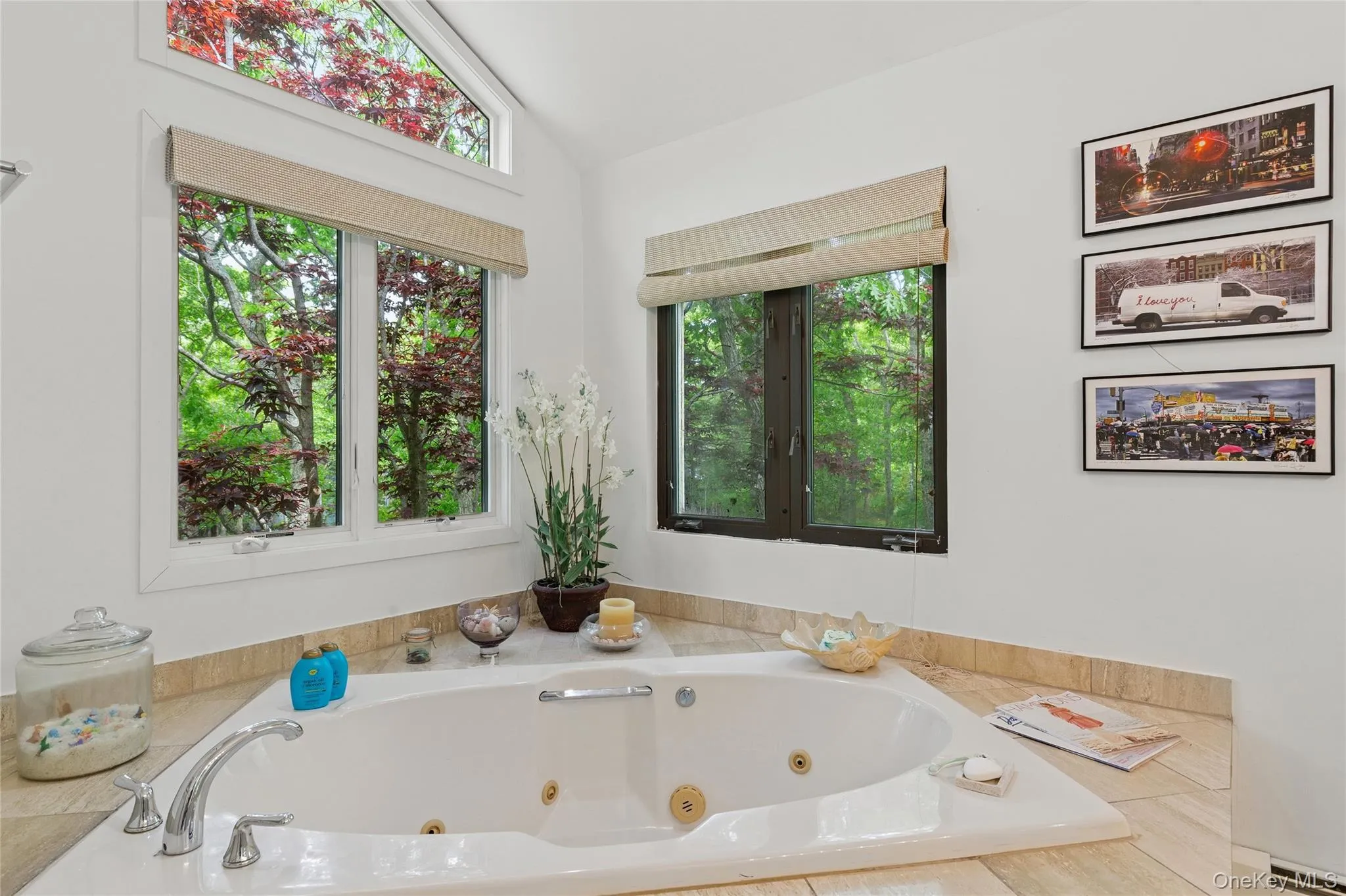 Full bath featuring baseboard heating, vaulted ceiling, a jetted tub, and plenty of natural light Full bath featuring baseboard heating, vaulted ceiling, a jetted tub, and plenty of natural light