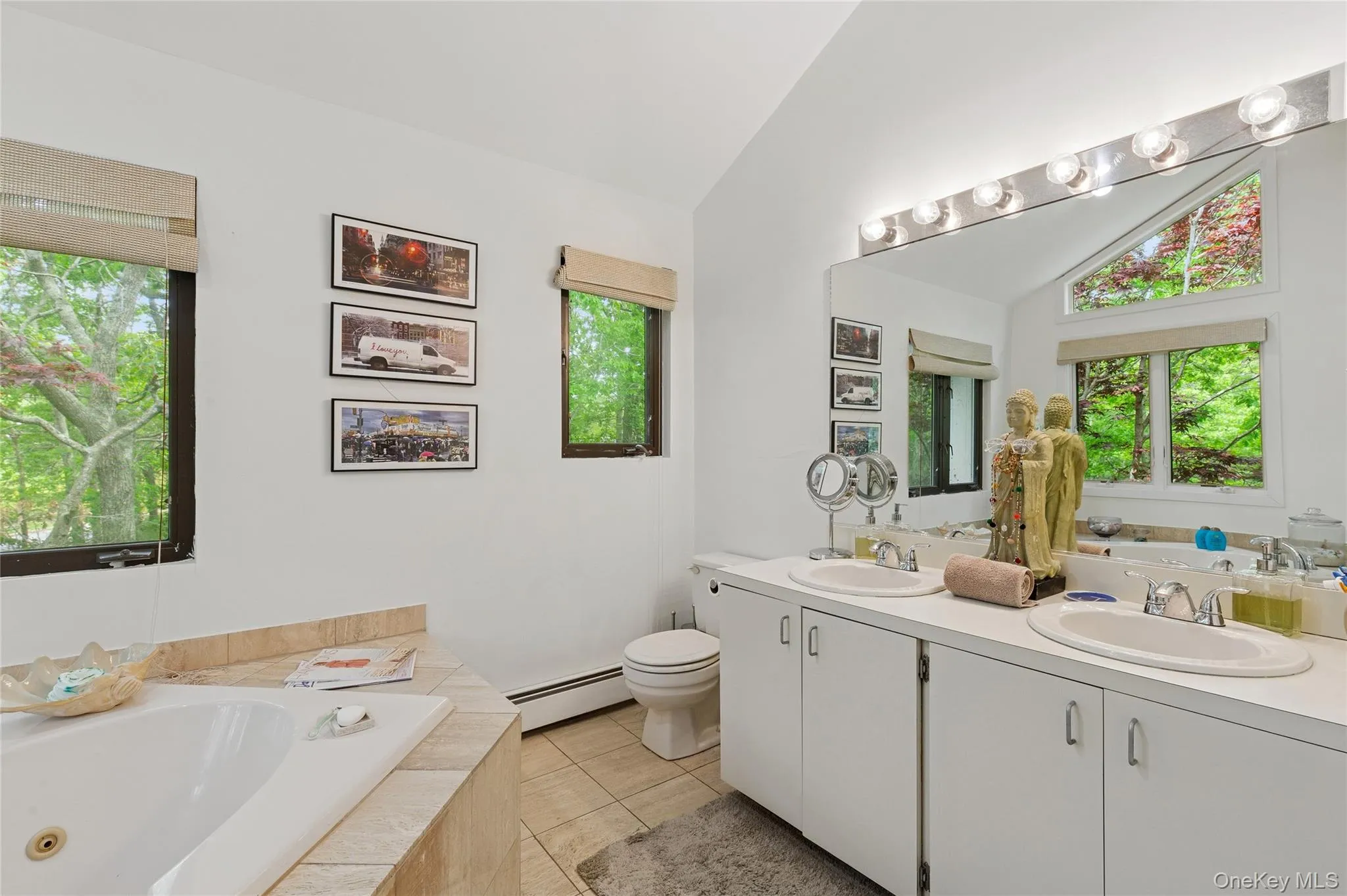 Bathroom with vaulted ceiling, a baseboard heating unit, double vanity, tile patterned floors, and a jetted tub Bathroom with vaulted ceiling, a baseboard heating unit, double vanity, tile patterned floors, and a jetted tub
