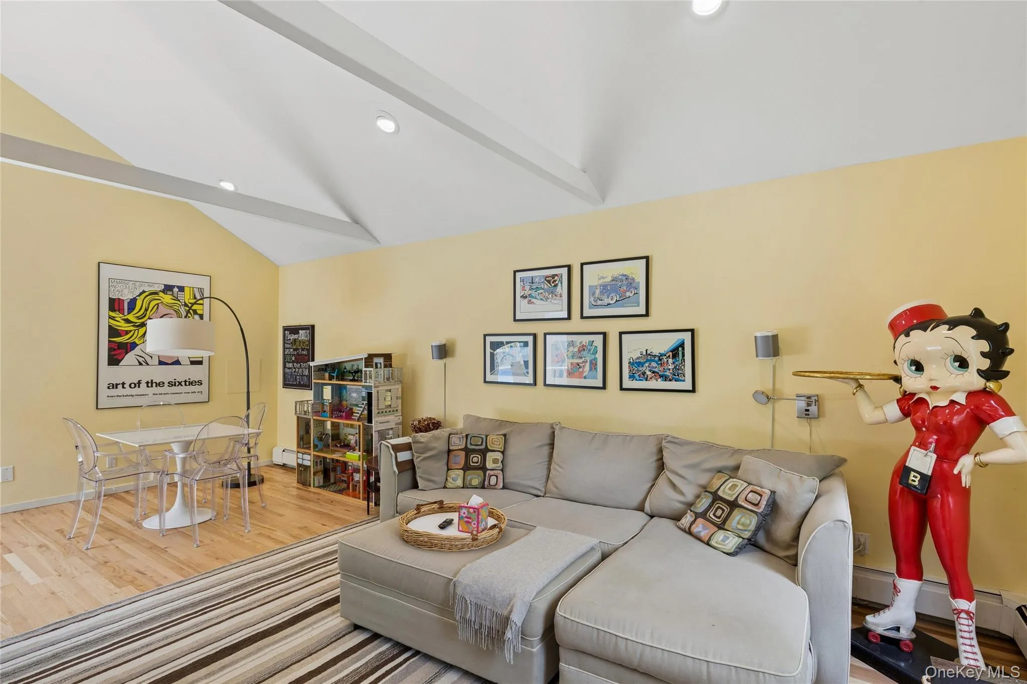 Living area with lofted ceiling, wood finished floors, and recessed lighting Living area with lofted ceiling, wood finished floors, and recessed lighting