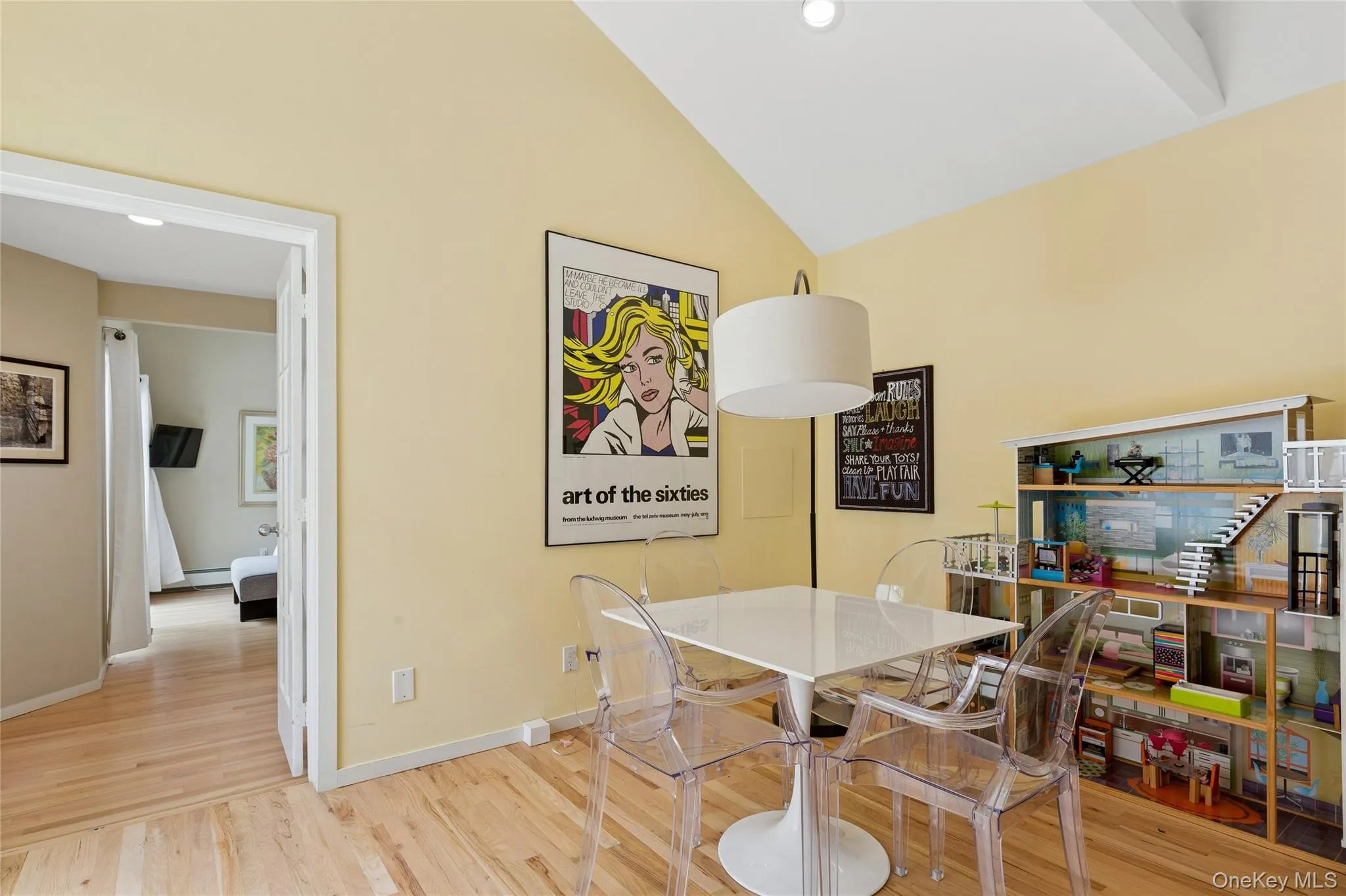 Dining area with wood finished floors, high vaulted ceiling, baseboards, and a baseboard heating unit Dining area with wood finished floors, high vaulted ceiling, baseboards, and a baseboard heating unit