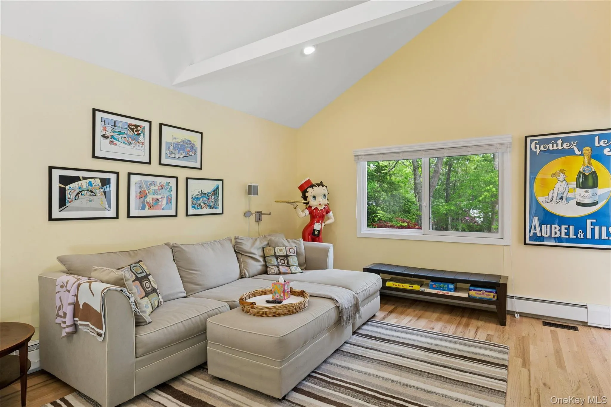 Living room featuring wood finished floors, high vaulted ceiling, and recessed lighting Living room featuring wood finished floors, high vaulted ceiling, and recessed lighting