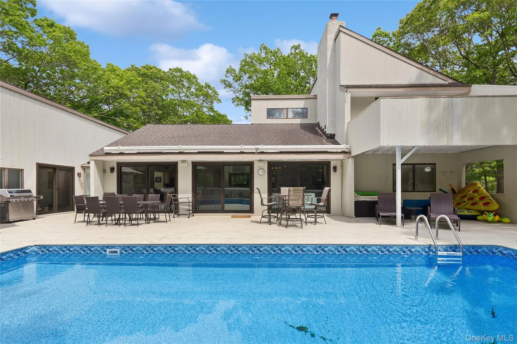 Outdoor pool with outdoor dining area, an outdoor living space, area for grilling, and a patio Outdoor pool with outdoor dining area, an outdoor living space, area for grilling, and a patio