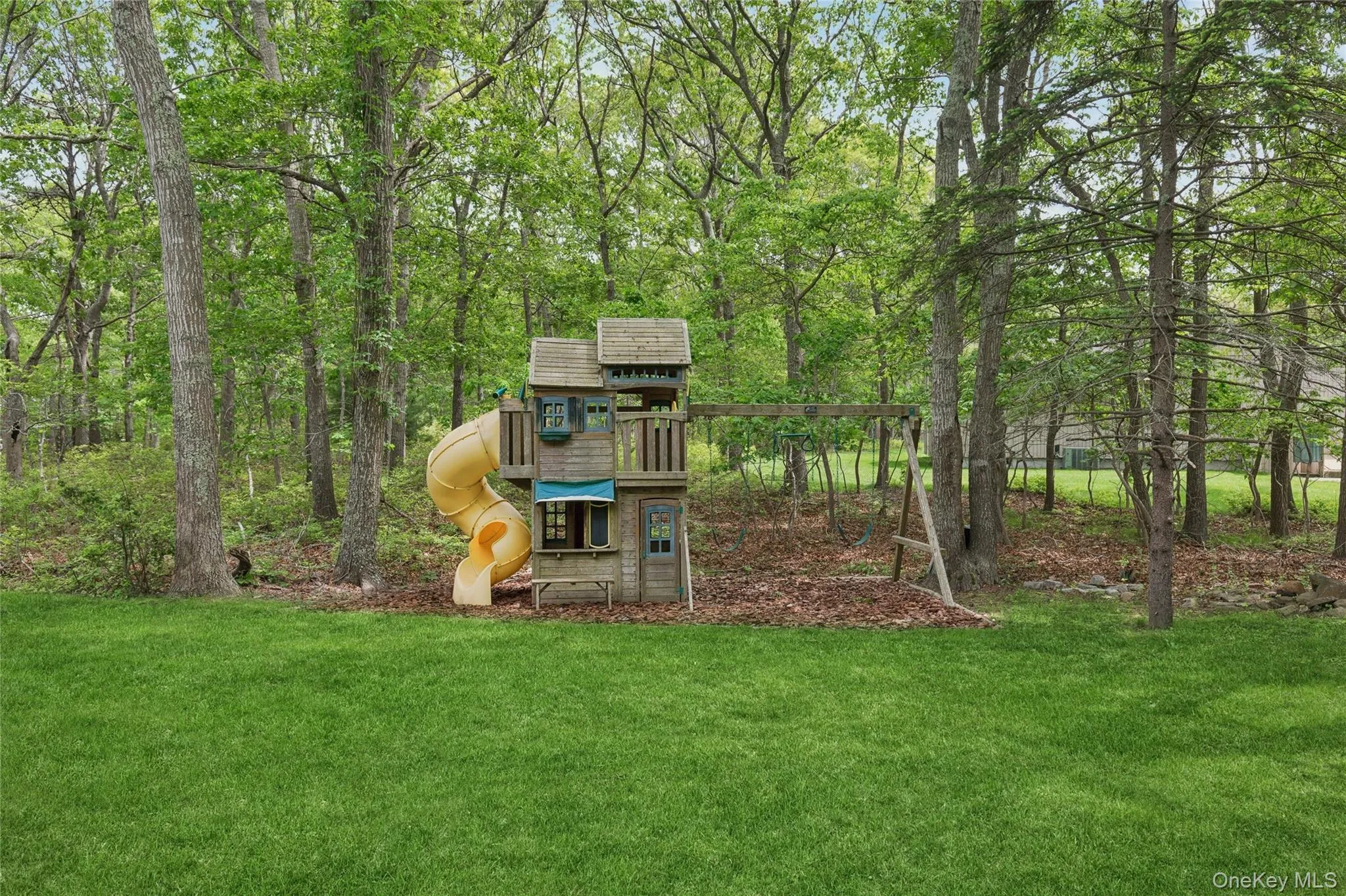View of grassy yard featuring a playground View of grassy yard featuring a playground