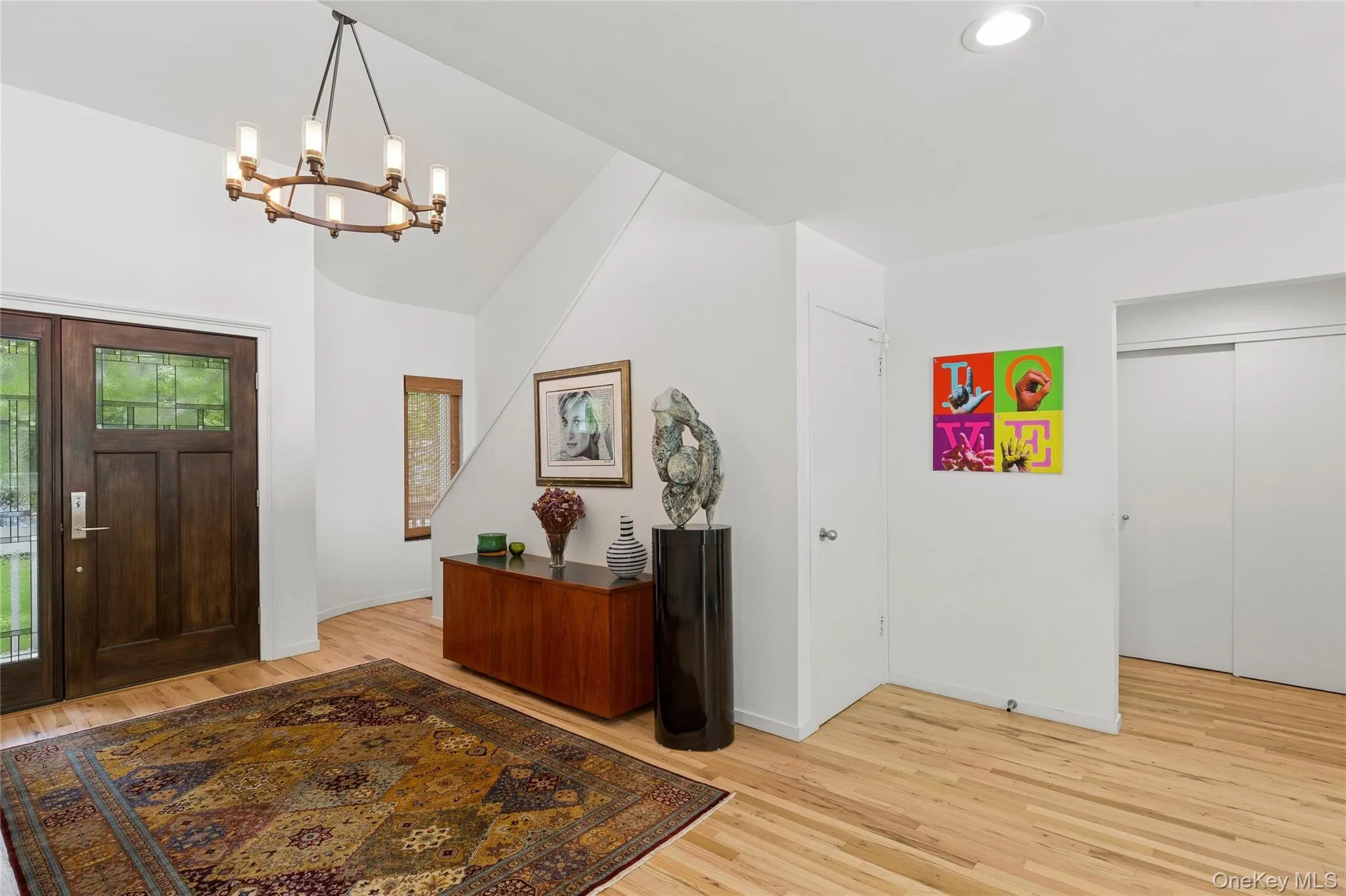 Entrance foyer with a chandelier, light wood finished floors, baseboards, and recessed lighting Entrance foyer with a chandelier, light wood finished floors, baseboards, and recessed lighting
