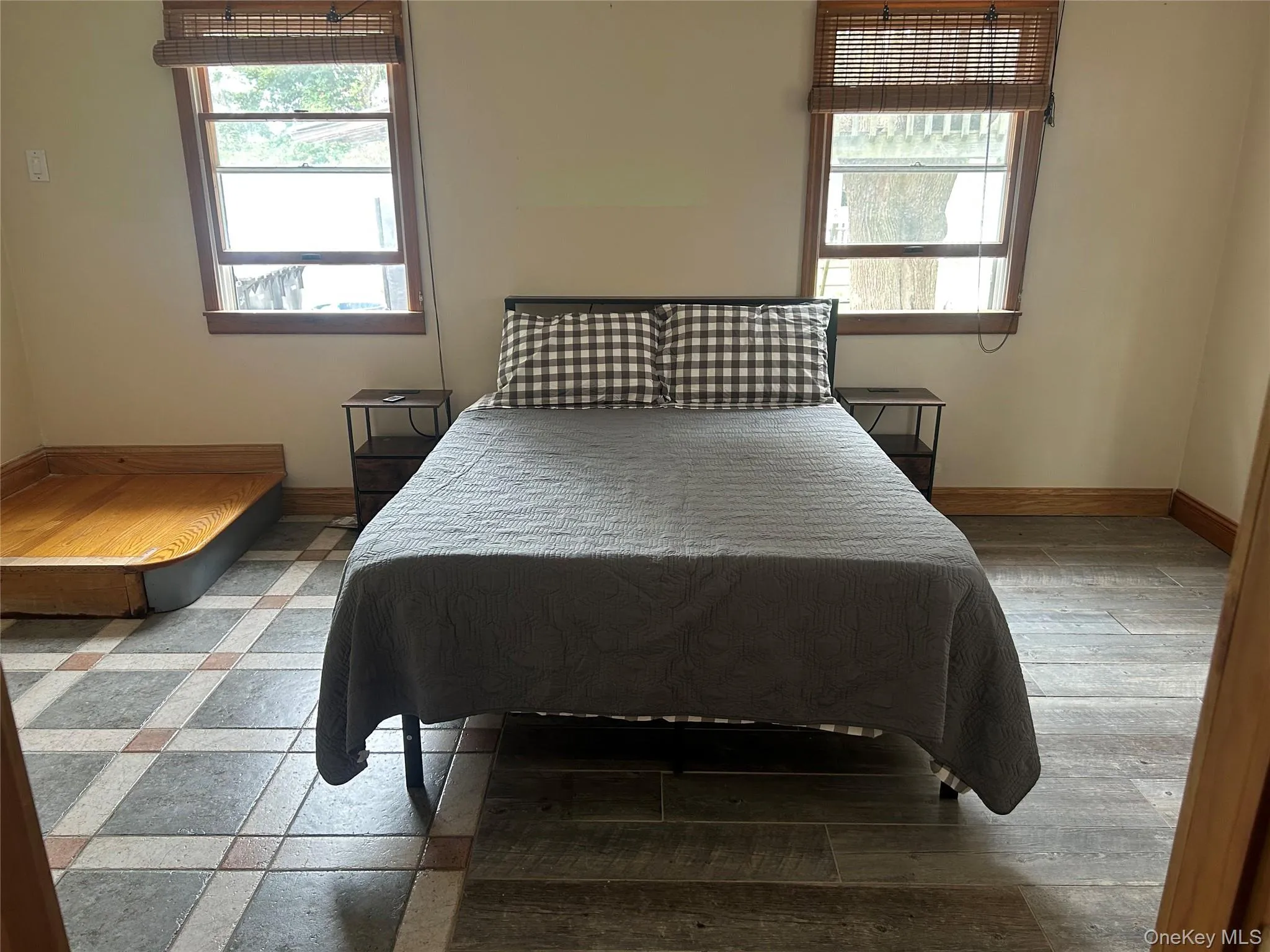 Bedroom with multiple windows and wood finished floors Bedroom with multiple windows and wood finished floors