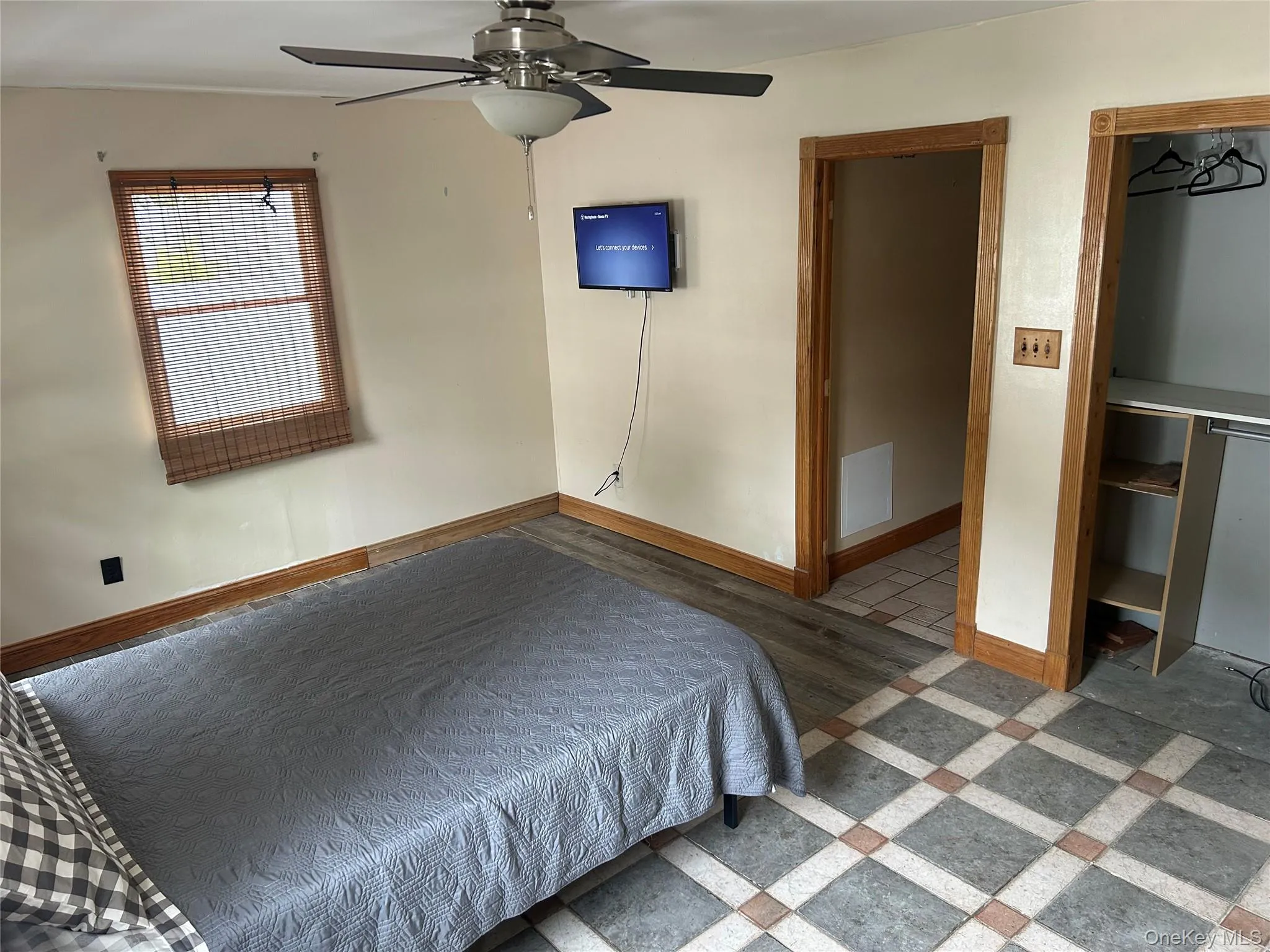 Bedroom with ceiling fan and tile patterned floors Bedroom with ceiling fan and tile patterned floors