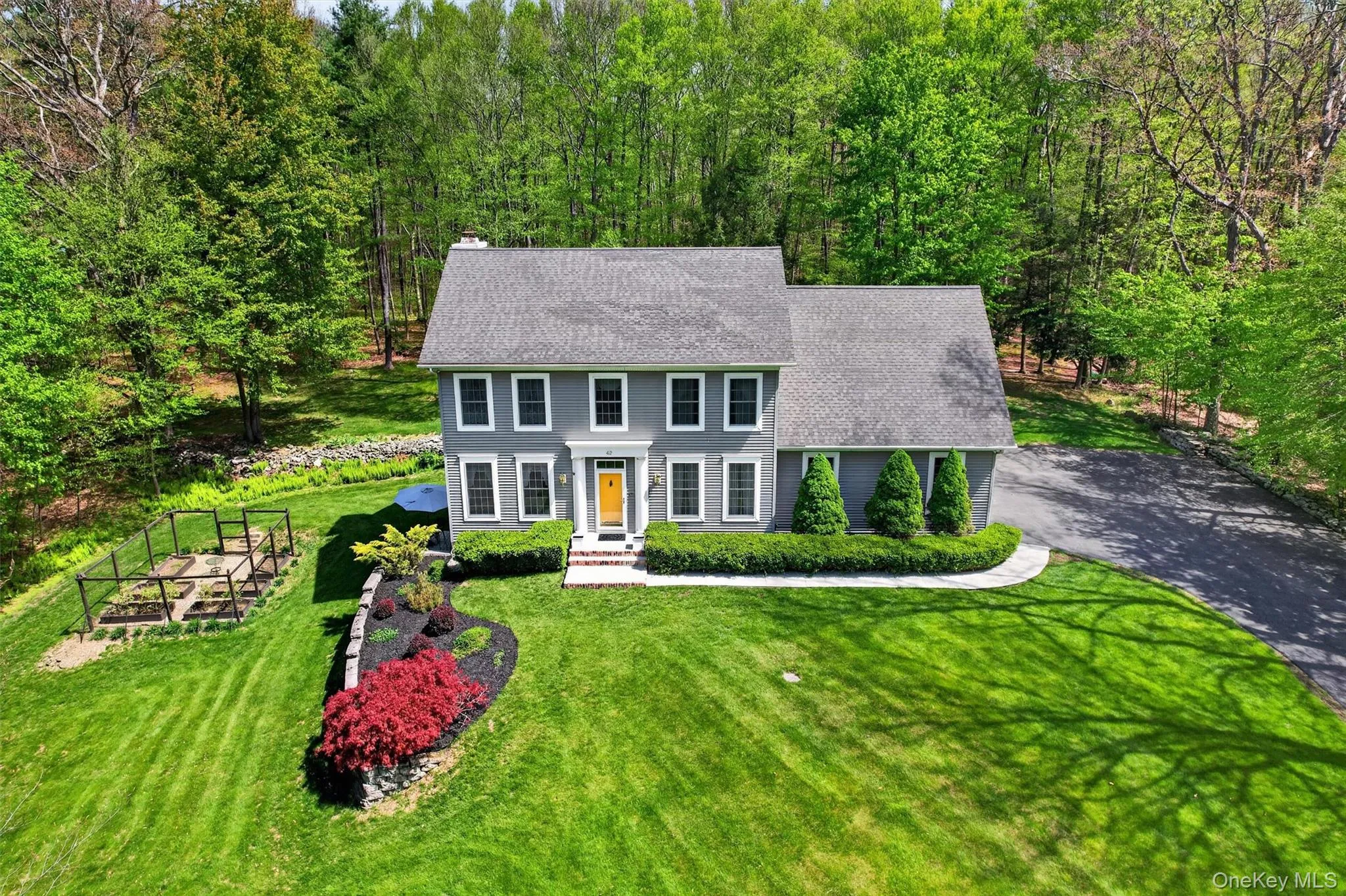 Home surrounded by garden and driveway Home surrounded by garden and driveway