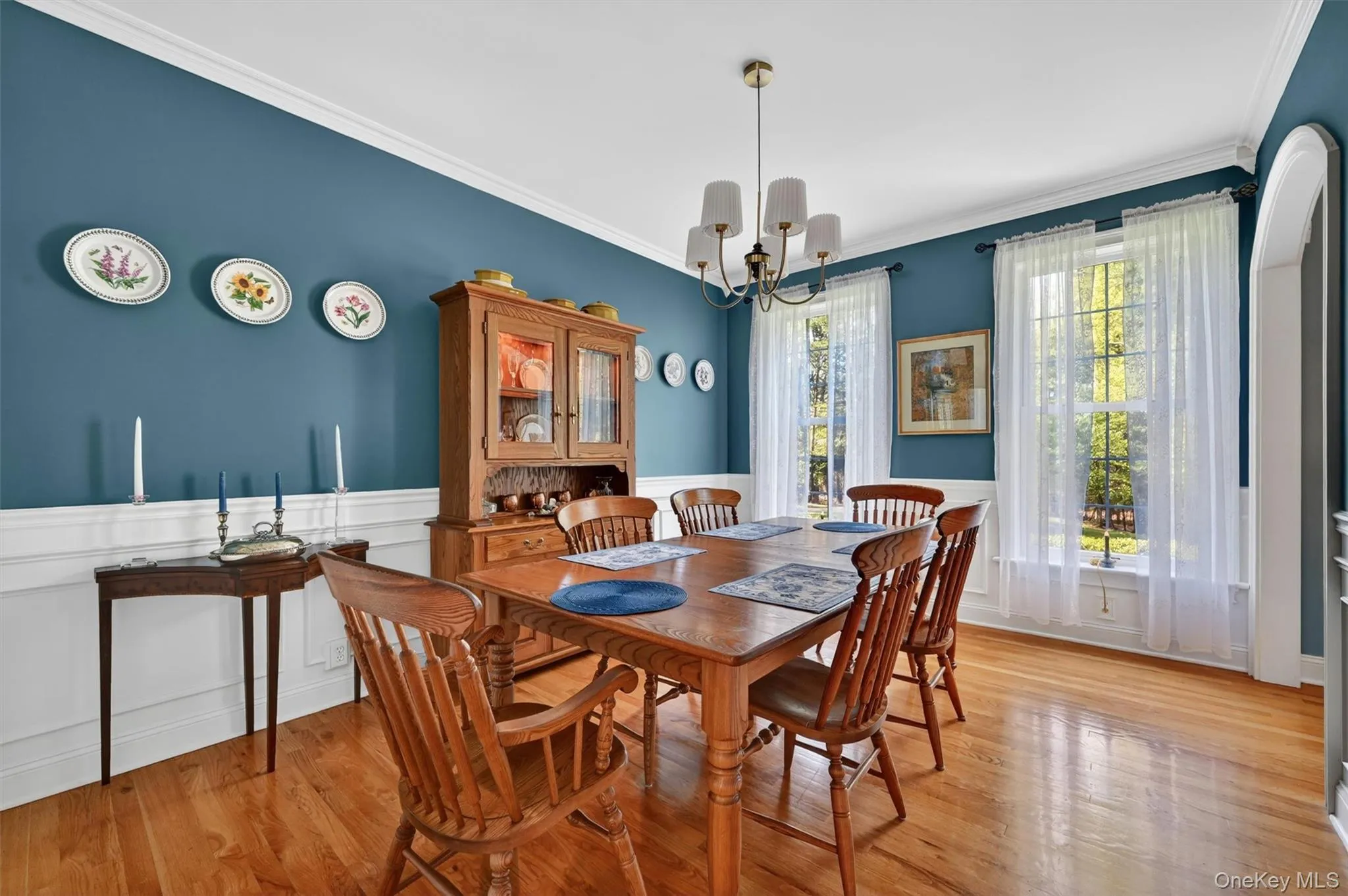Dining room with hardwood floors and large windows Dining room with hardwood floors and large windows