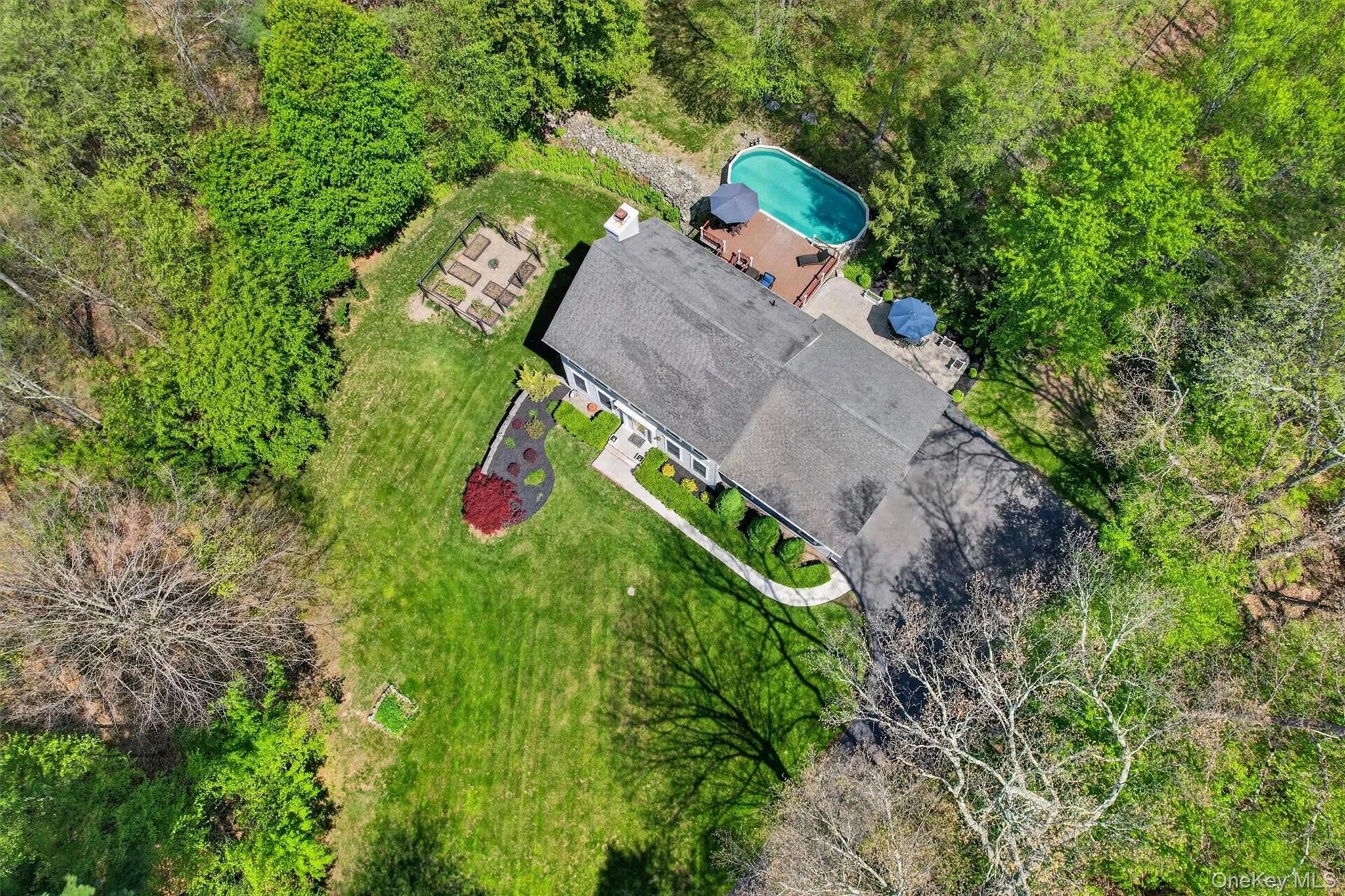 View of home with front walkway, garden and pool View of home with front walkway, garden and pool