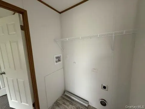 Washroom featuring crown molding, washer hookup, hookup for an electric dryer, and laundry area Washroom featuring crown molding, washer hookup, hookup for an electric dryer, and laundry area