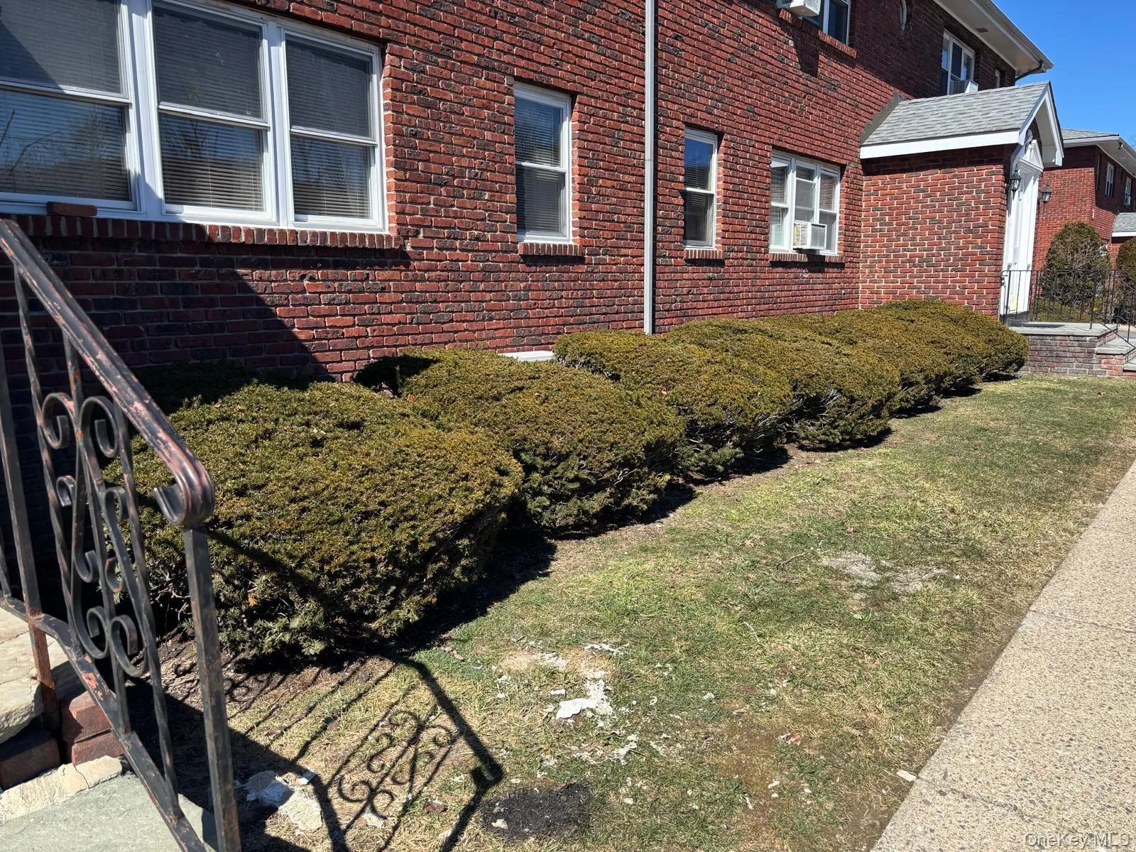 View of side of home with brick siding and a yard View of side of home with brick siding and a yard