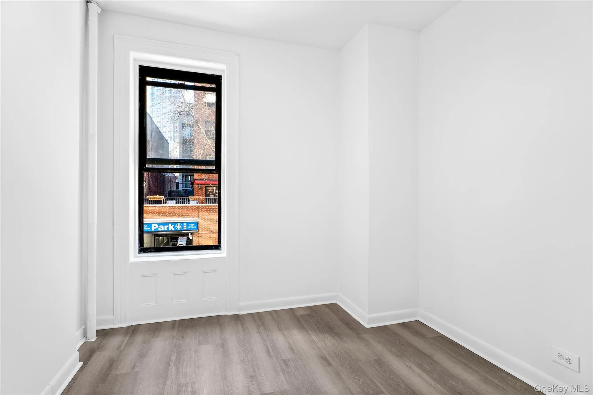 Empty room with baseboards and wood finished floors Empty room with baseboards and wood finished floors