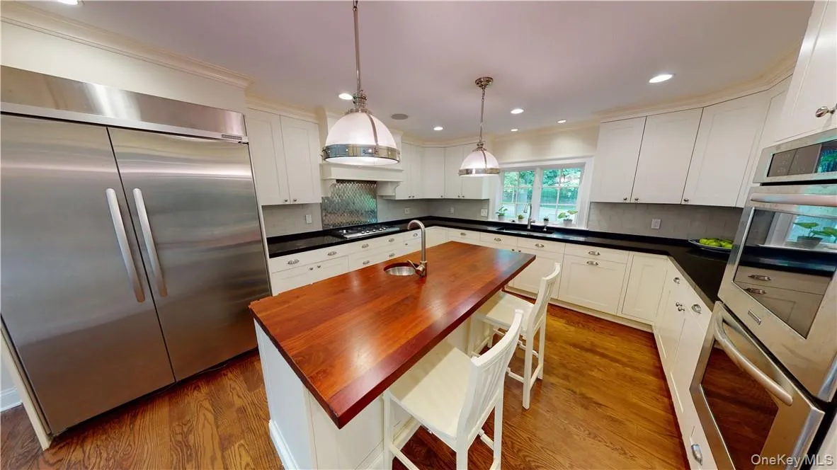 Modern hi-end chef's kitchen with stainless appliances and Bilotta custom kitchen cabinetry. Modern hi-end chef's kitchen with stainless appliances and Bilotta custom kitchen cabinetry.