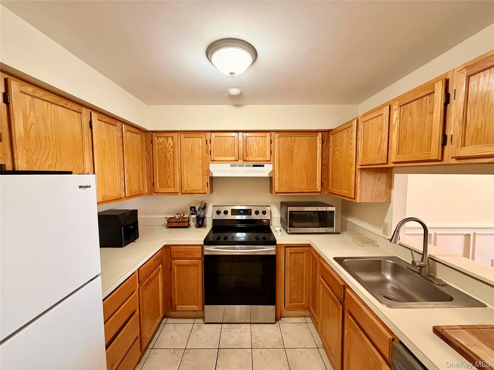 A functional U-shaped layout makes the most of every inch, with updated stainless steel appliances including a 2019 range and a brand new 2025 dishwasher. A functional U-shaped layout makes the most of every inch, with updated stainless steel appliances including a 2019 range and a brand new 2025 dishwasher.