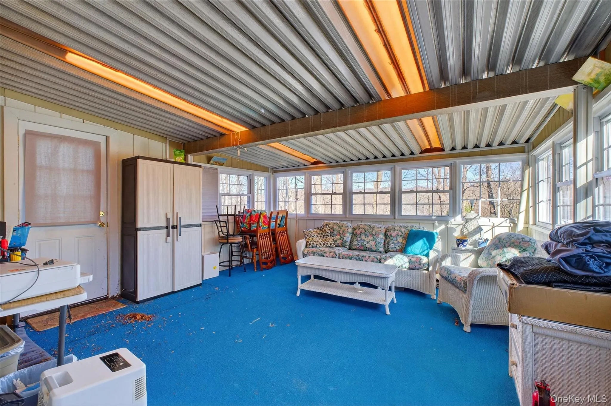 Sunroom featuring an outdoor living space Sunroom featuring an outdoor living space
