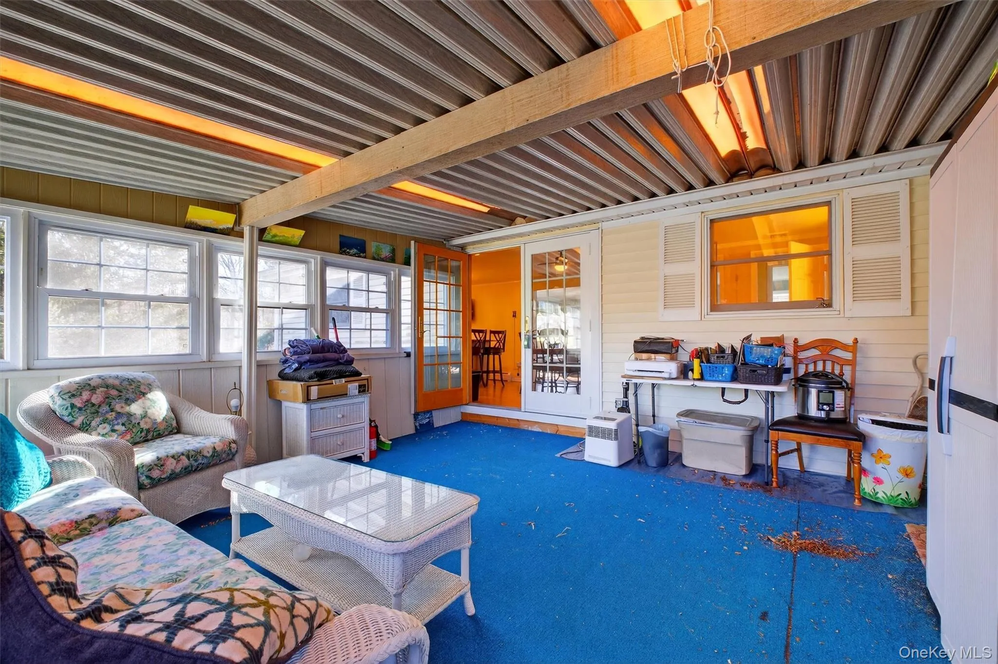 Sunroom with carpet flooring and wooden walls Sunroom with carpet flooring and wooden walls