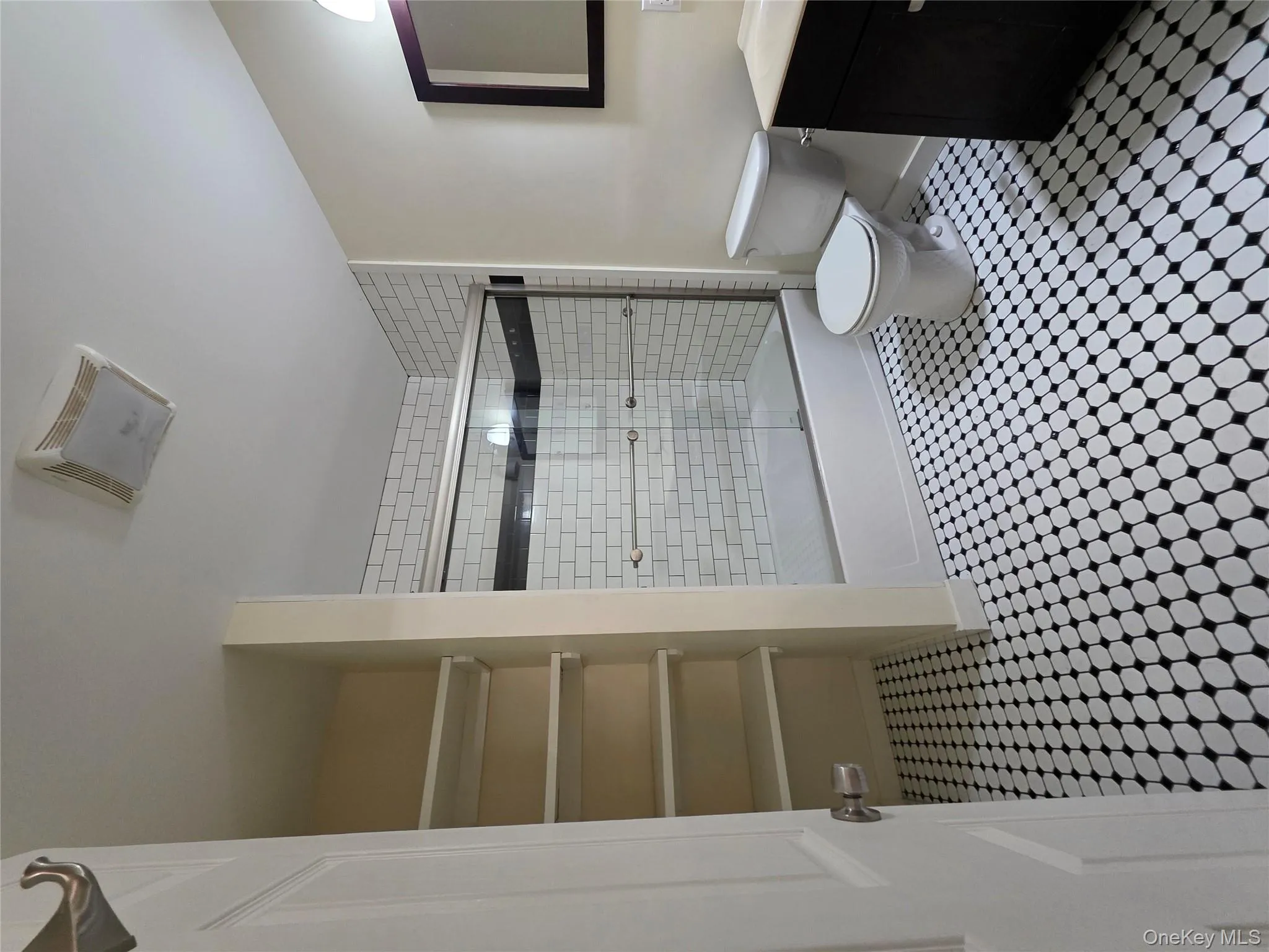 Bathroom featuring vanity and shower / bath combination with glass door Bathroom featuring vanity and shower / bath combination with glass door