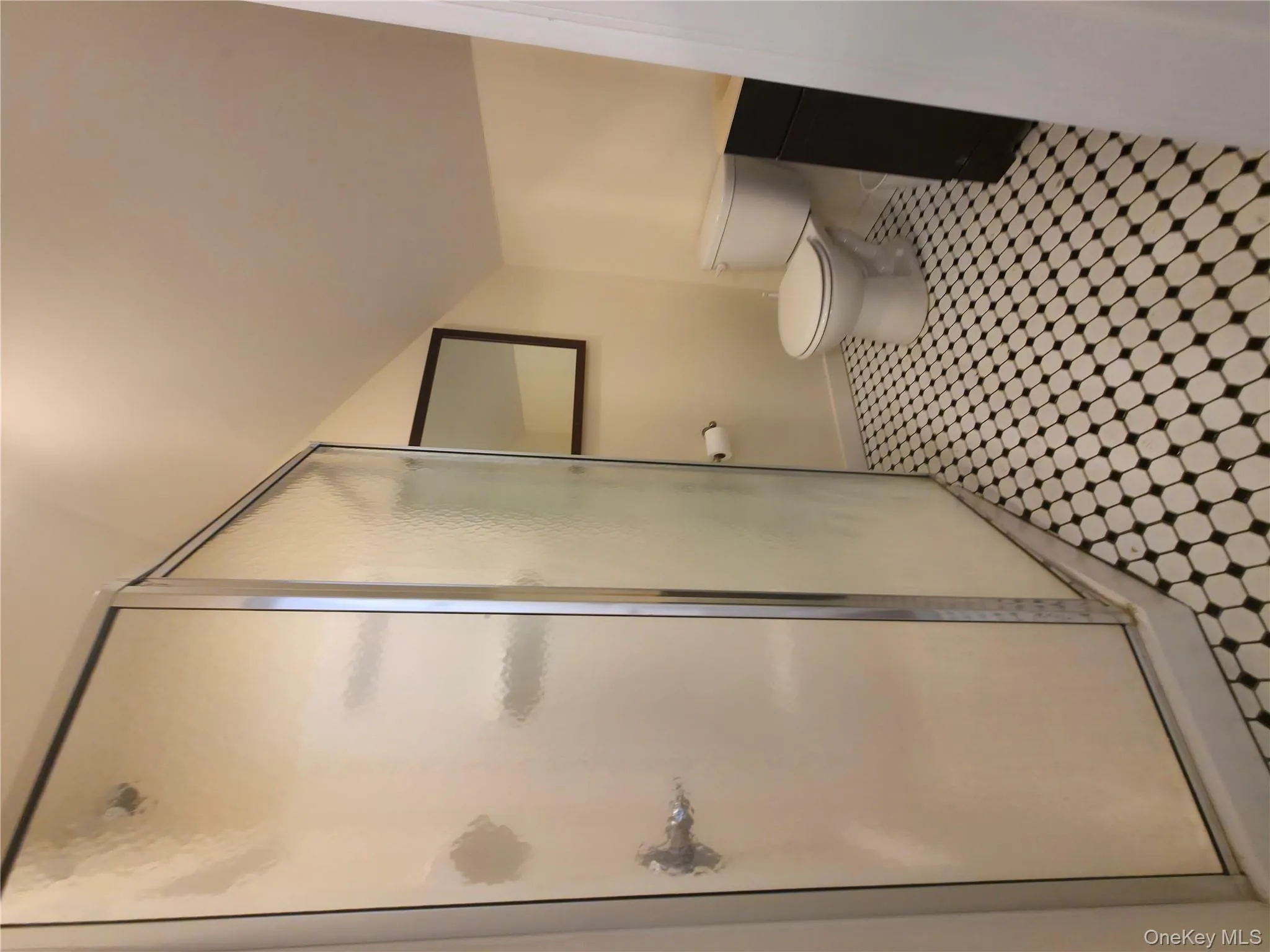 Loft Bathroom with a stall shower, baseboards, lofted ceiling, and toilet Loft Bathroom with a stall shower, baseboards, lofted ceiling, and toilet