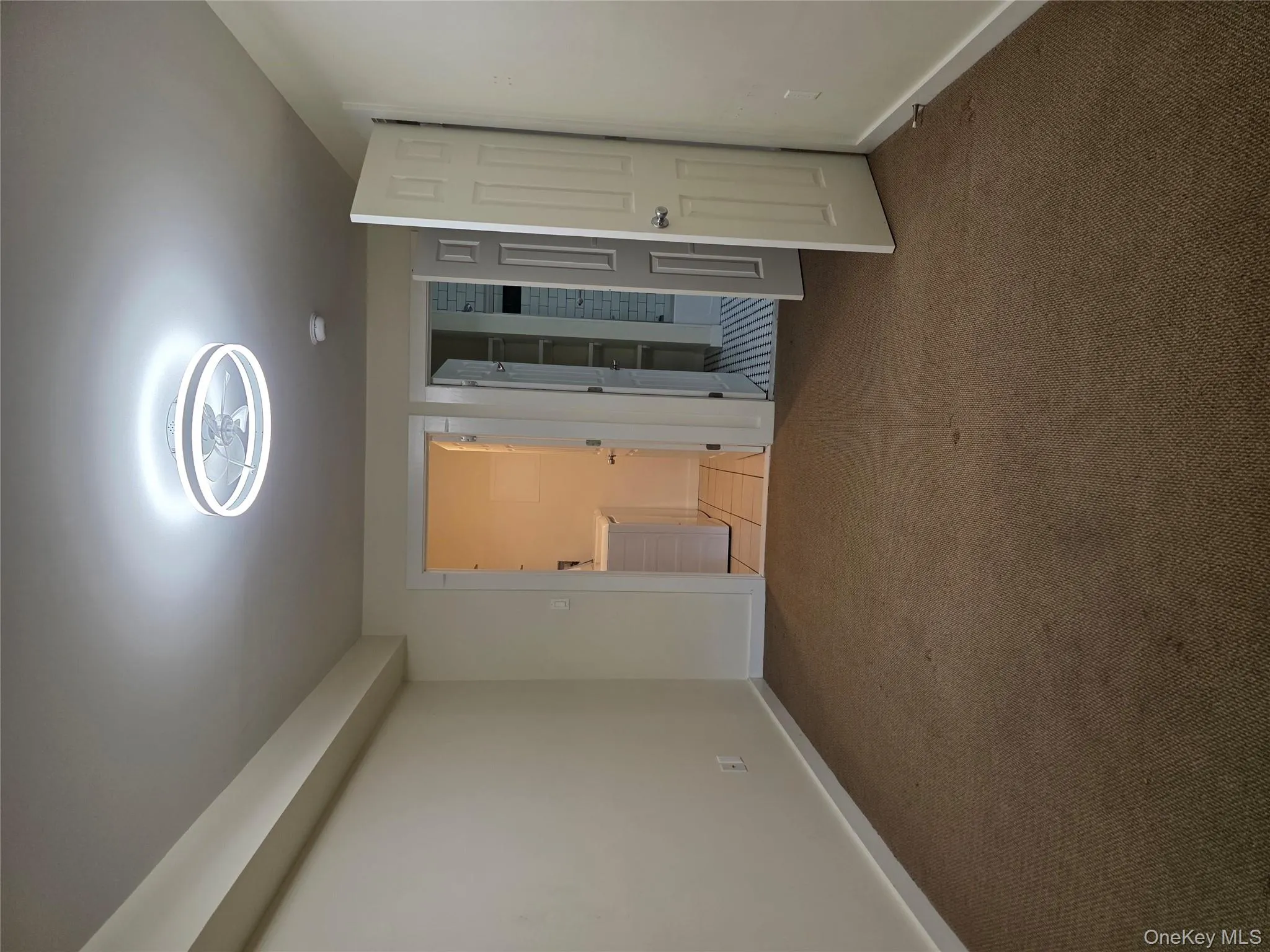 Unfurnished bedroom featuring connected bathroom, carpet floors, and washer and clothes dryer Unfurnished bedroom featuring connected bathroom, carpet floors, and washer and clothes dryer