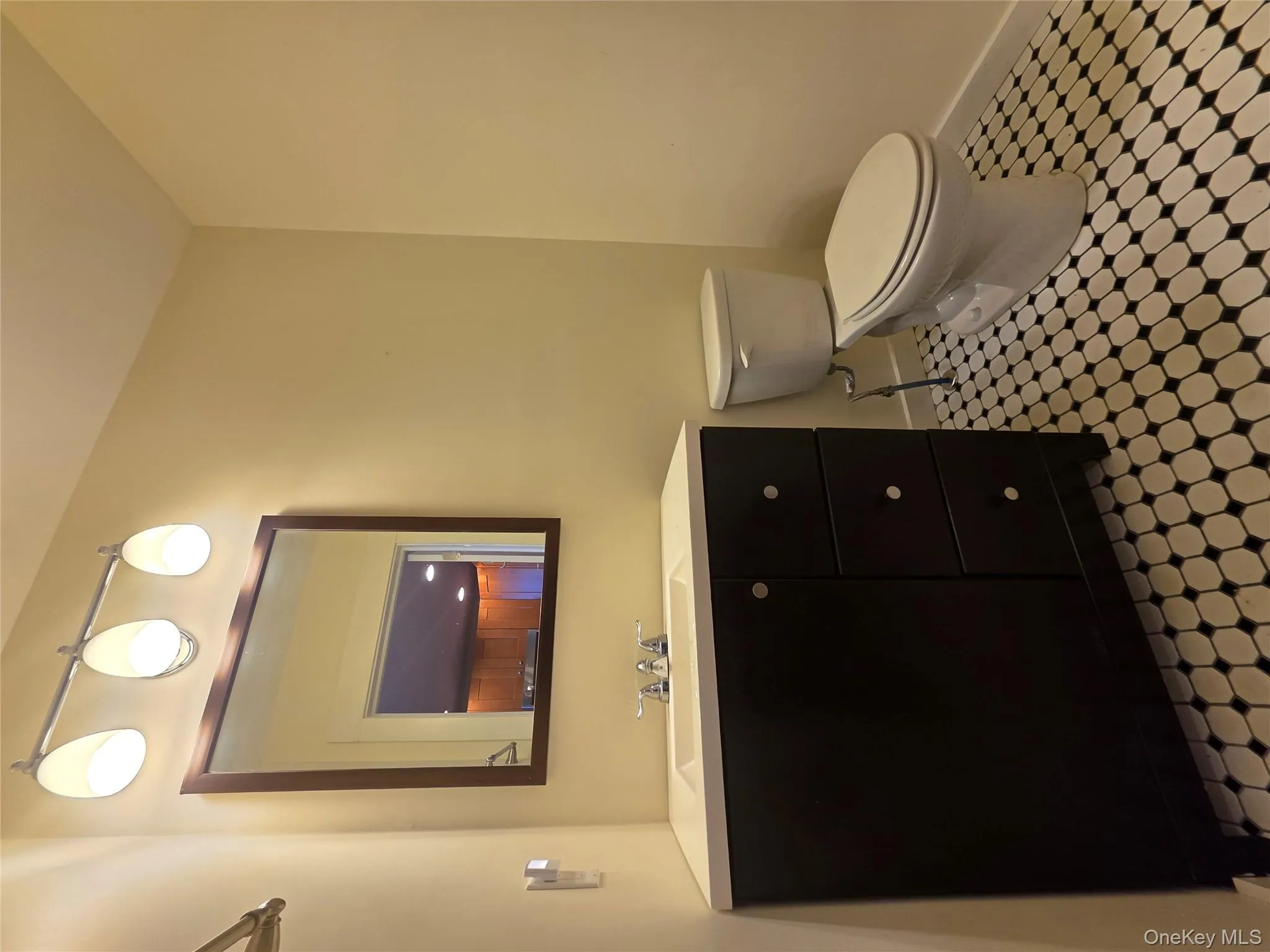 Bathroom featuring toilet, vanity, and baseboards Bathroom featuring toilet, vanity, and baseboards