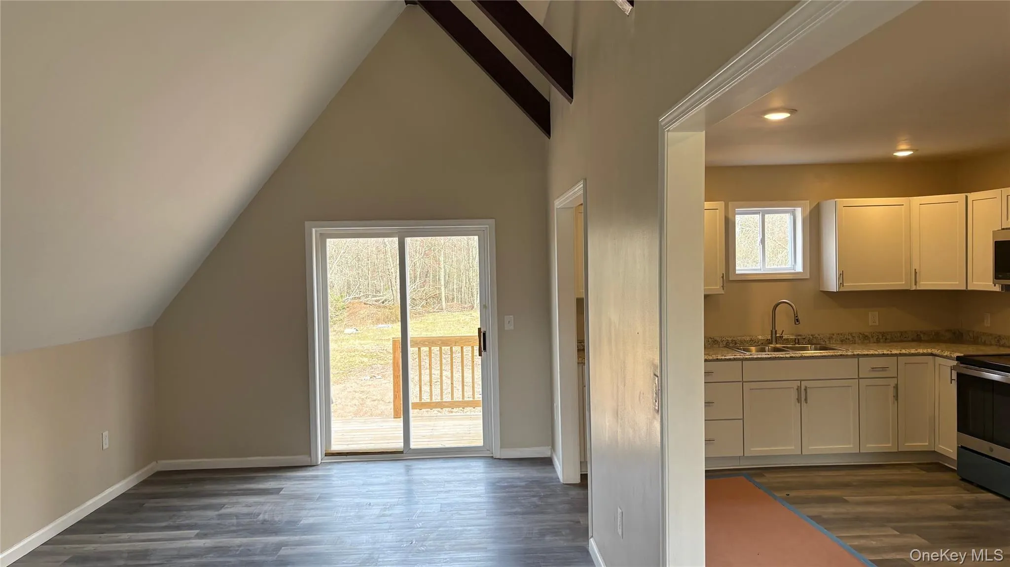 Kitchen featuring , stainless steel appliances, white cabinetry, and light stone countertops Kitchen featuring , stainless steel appliances, white cabinetry, and light stone countertops