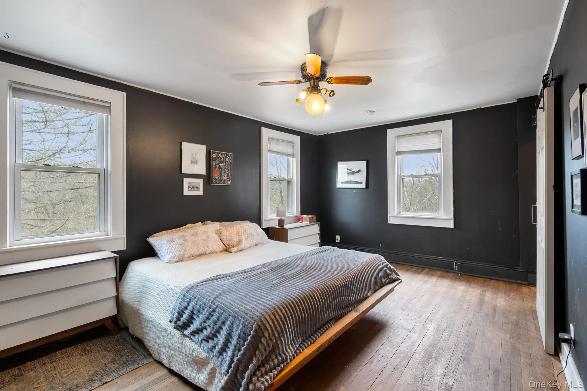 Generous sized primary bedroom featuring hardwood floors. Generous sized primary bedroom featuring hardwood floors.