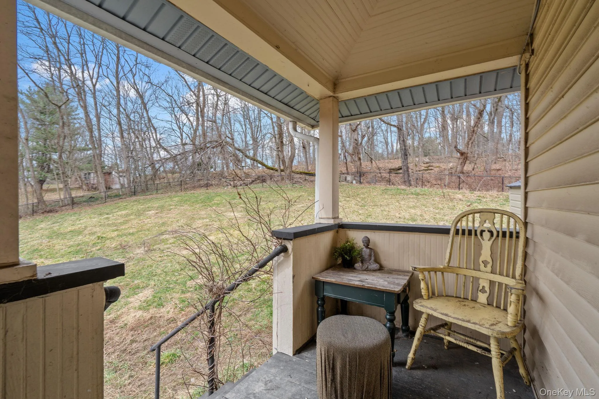 Second level entry with porch overlooking the fenced yard space. Second level entry with porch overlooking the fenced yard space.
