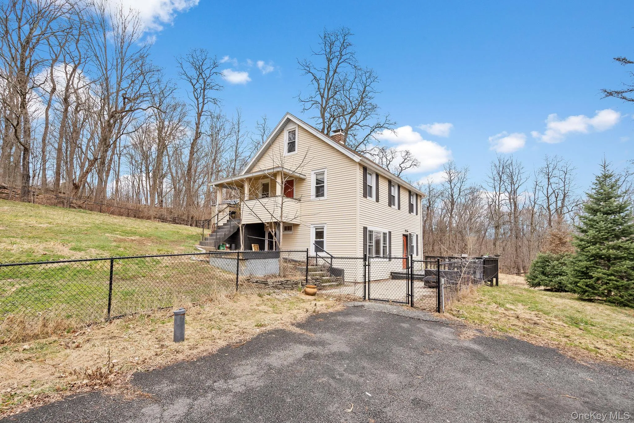 Partially fenced yard with patio. Partially fenced yard with patio.