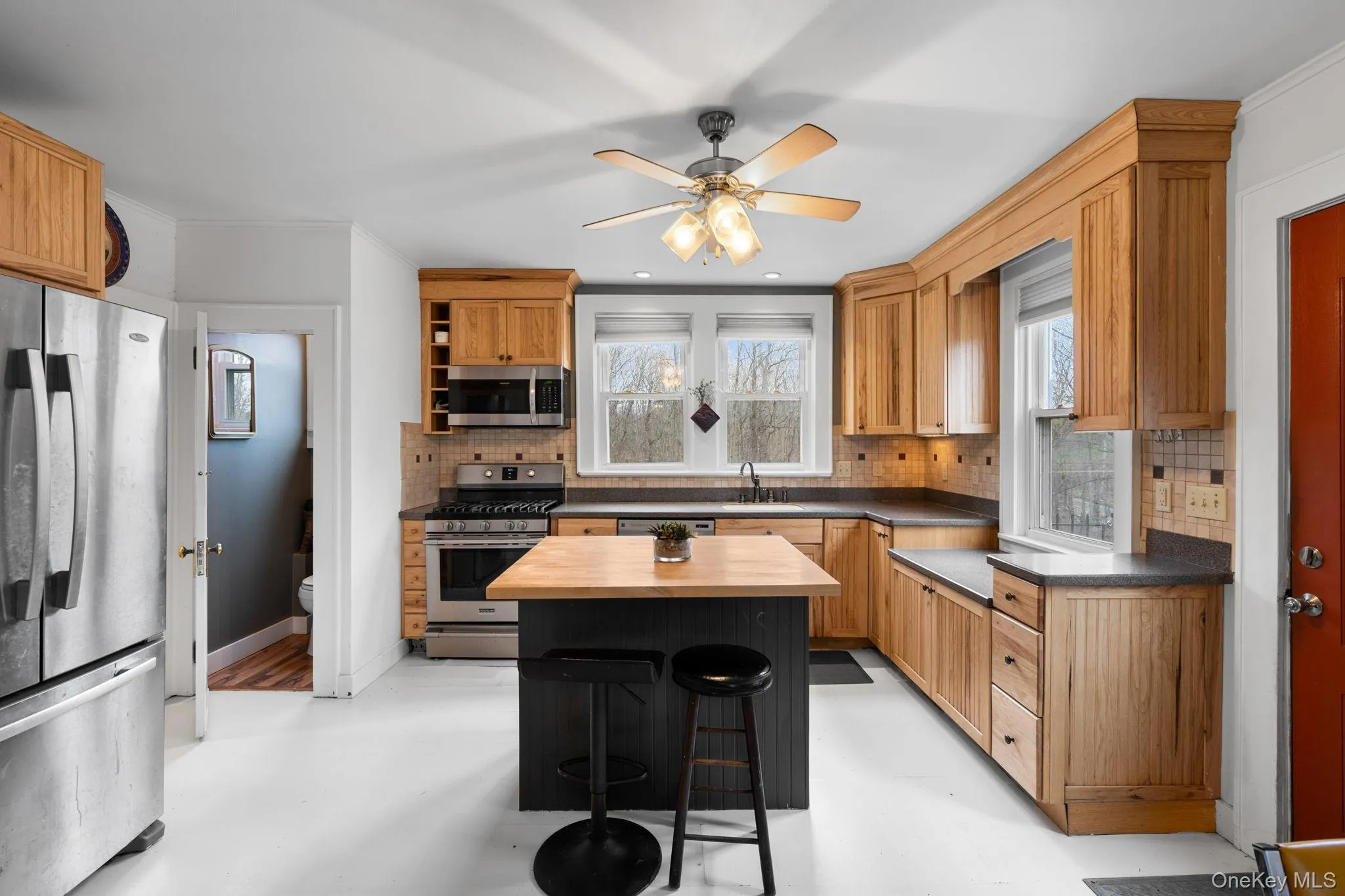 Updated kitchen features island, stainless appliances and ample cabinet space. Updated kitchen features island, stainless appliances and ample cabinet space.