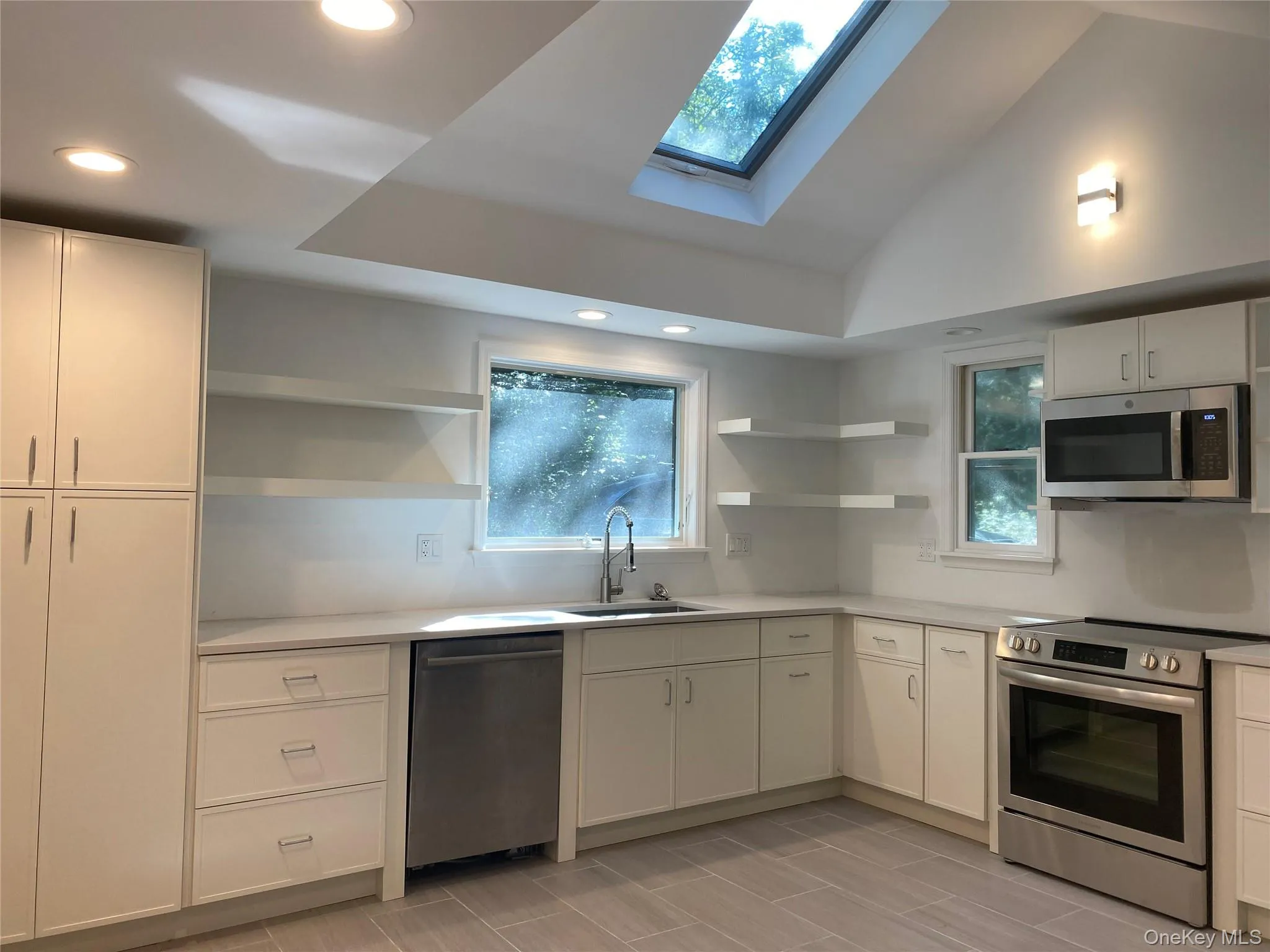 Kitchen featuring open shelves, stainless steel appliances, plenty of natural light, recessed lighting, and white cabinetry Kitchen featuring open shelves, stainless steel appliances, plenty of natural light, recessed lighting, and white cabinetry