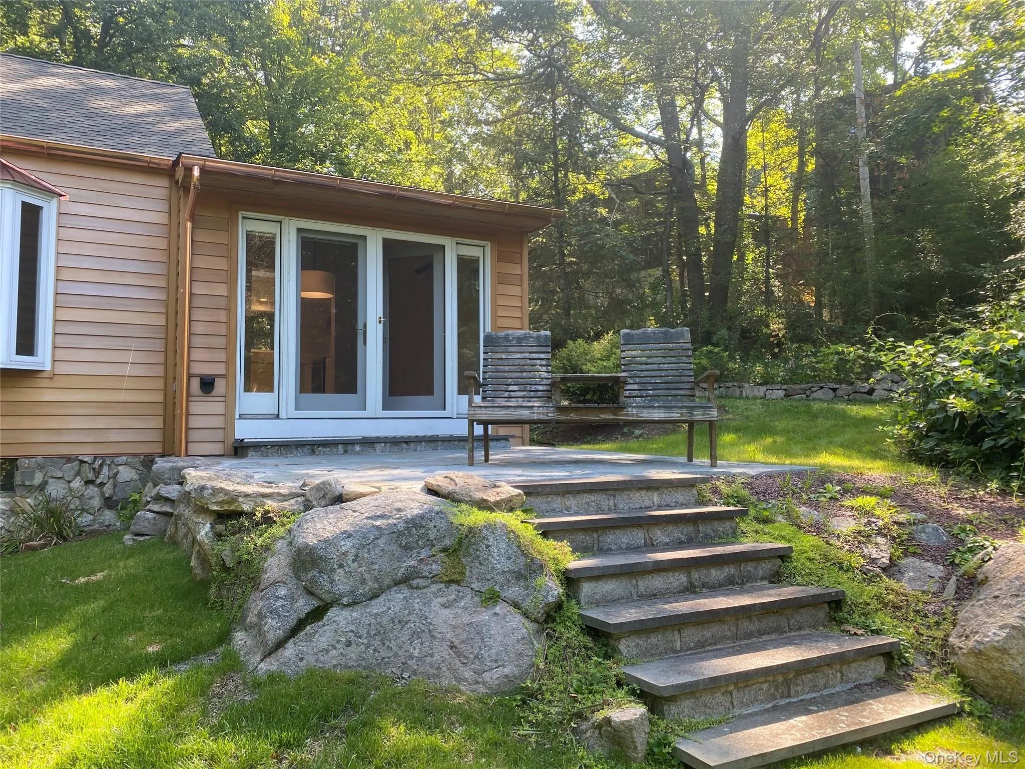 Property entrance with french doors, a patio area, and a yard Property entrance with french doors, a patio area, and a yard