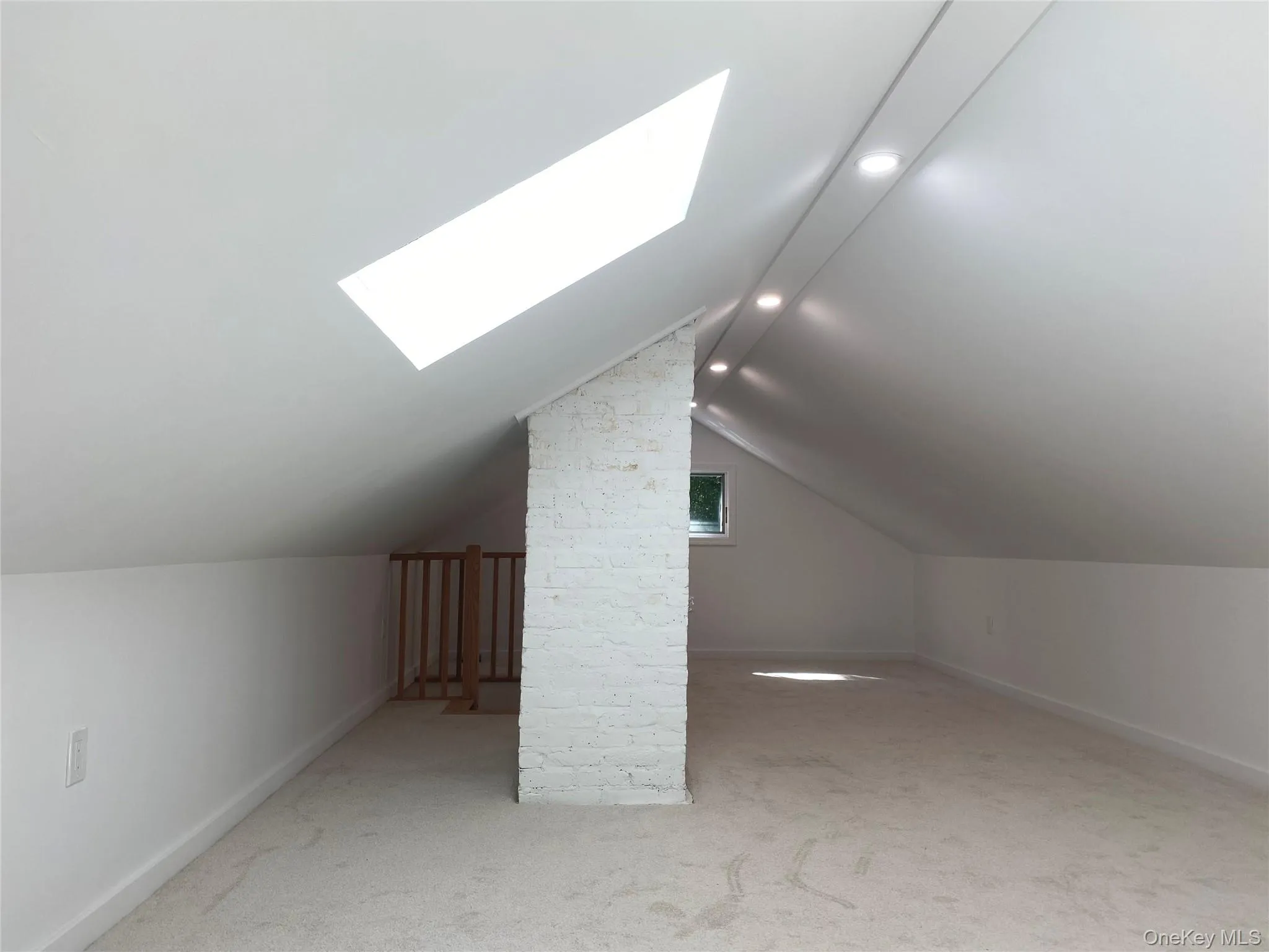 Bonus room with a skylight, light colored carpet, recessed lighting, and lofted ceiling Bonus room with a skylight, light colored carpet, recessed lighting, and lofted ceiling