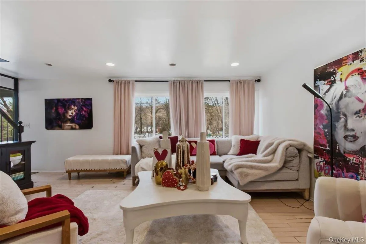 Living room with light wood-style floors and recessed lighting Living room with light wood-style floors and recessed lighting