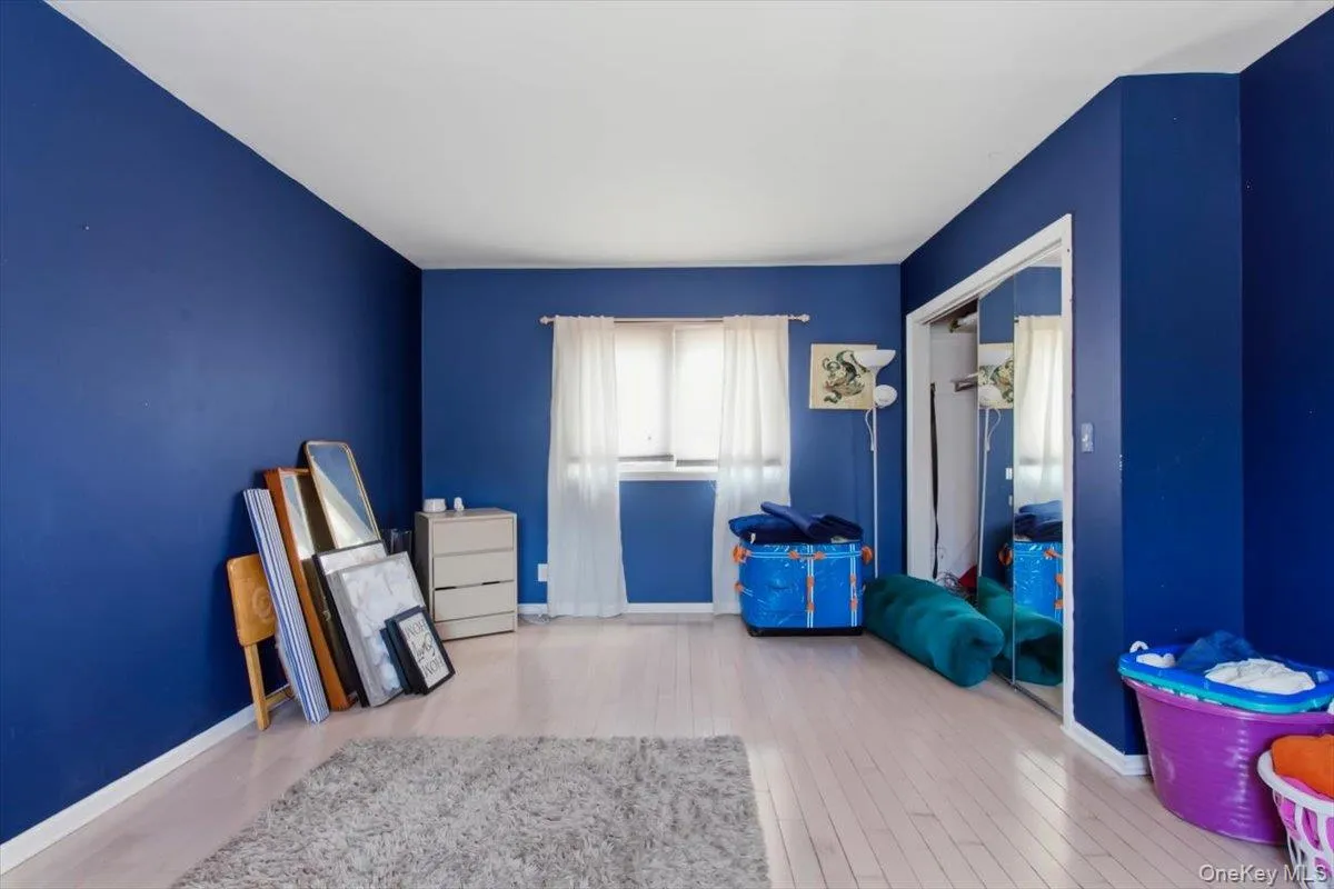 Bedroom featuring baseboards and light wood-type flooring Bedroom featuring baseboards and light wood-type flooring