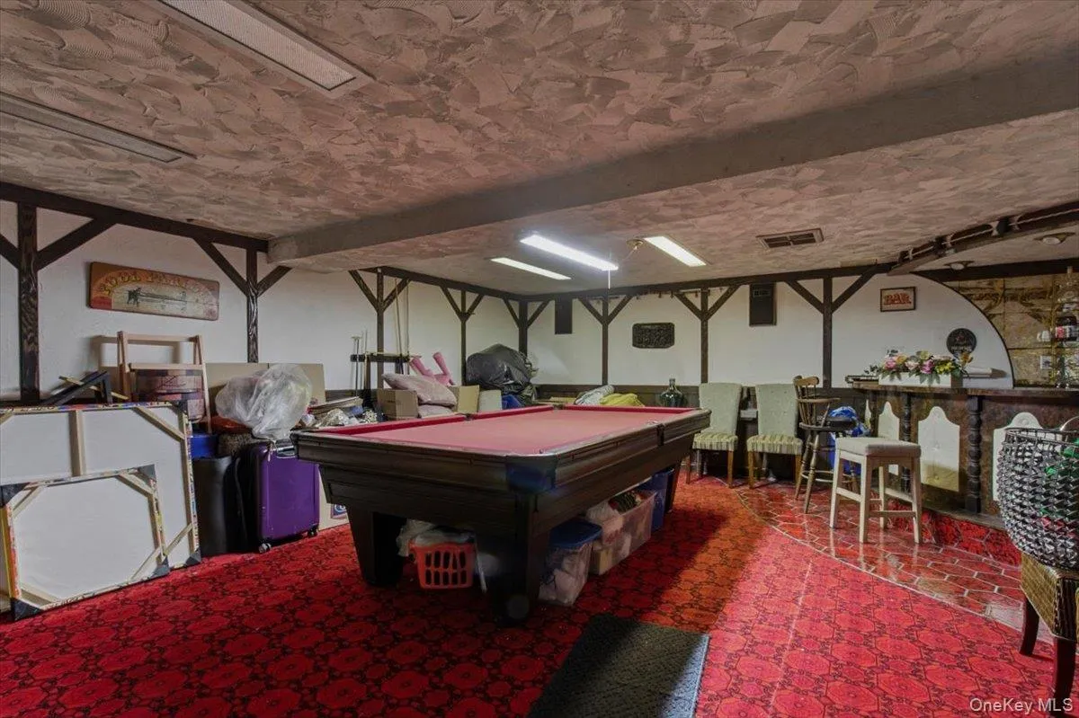 Recreation room with pool table, tile patterned floors and bar Recreation room with pool table, tile patterned floors and bar