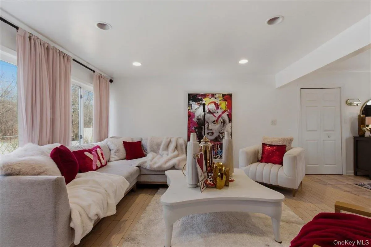 Living area with light wood-style flooring and recessed lighting Living area with light wood-style flooring and recessed lighting