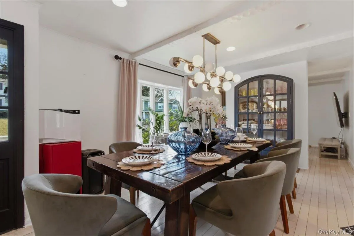 Dining room with hanging lights and light wood-style floors Dining room with hanging lights and light wood-style floors