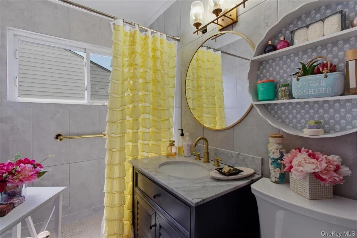 Bathroom featuring vanity and a tile shower Bathroom featuring vanity and a tile shower